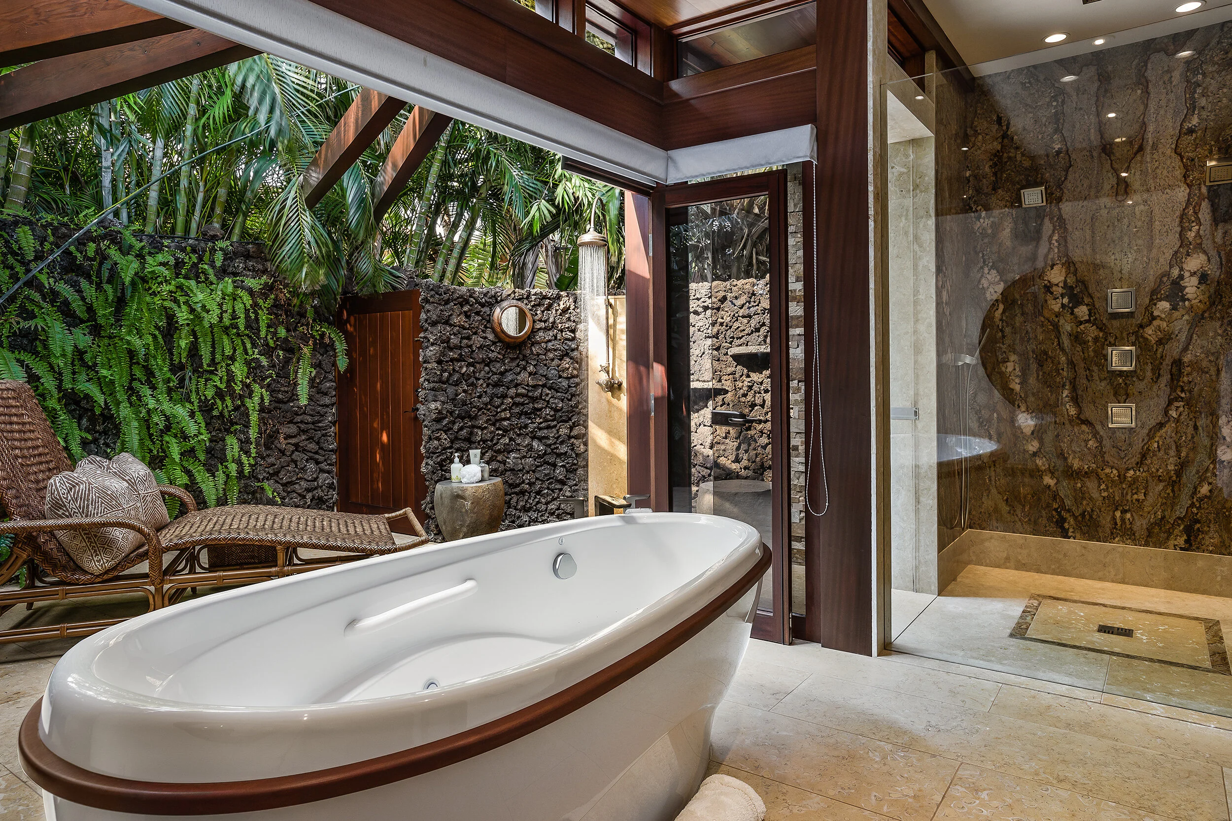 Motorized pocketing doors expand the luxurious master bathroom to the outdoor shower oasis.