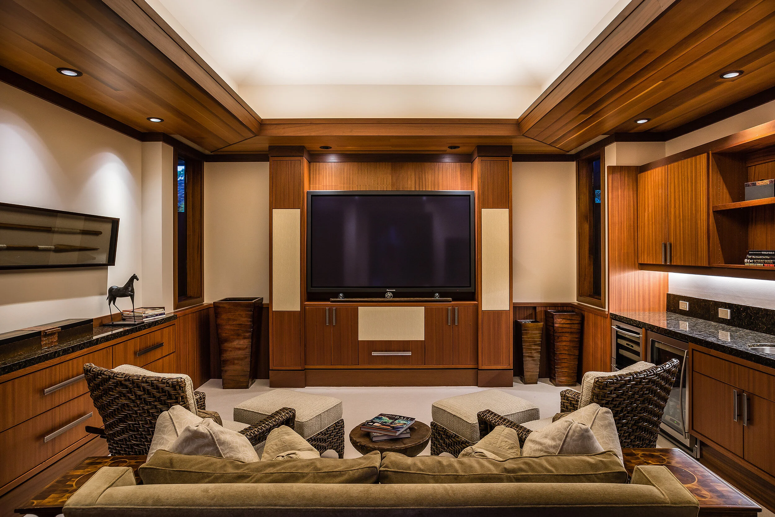 Media room with surround sound speaker system, black out shades and wet bar with refrigerated wine cooler and beverage center.
