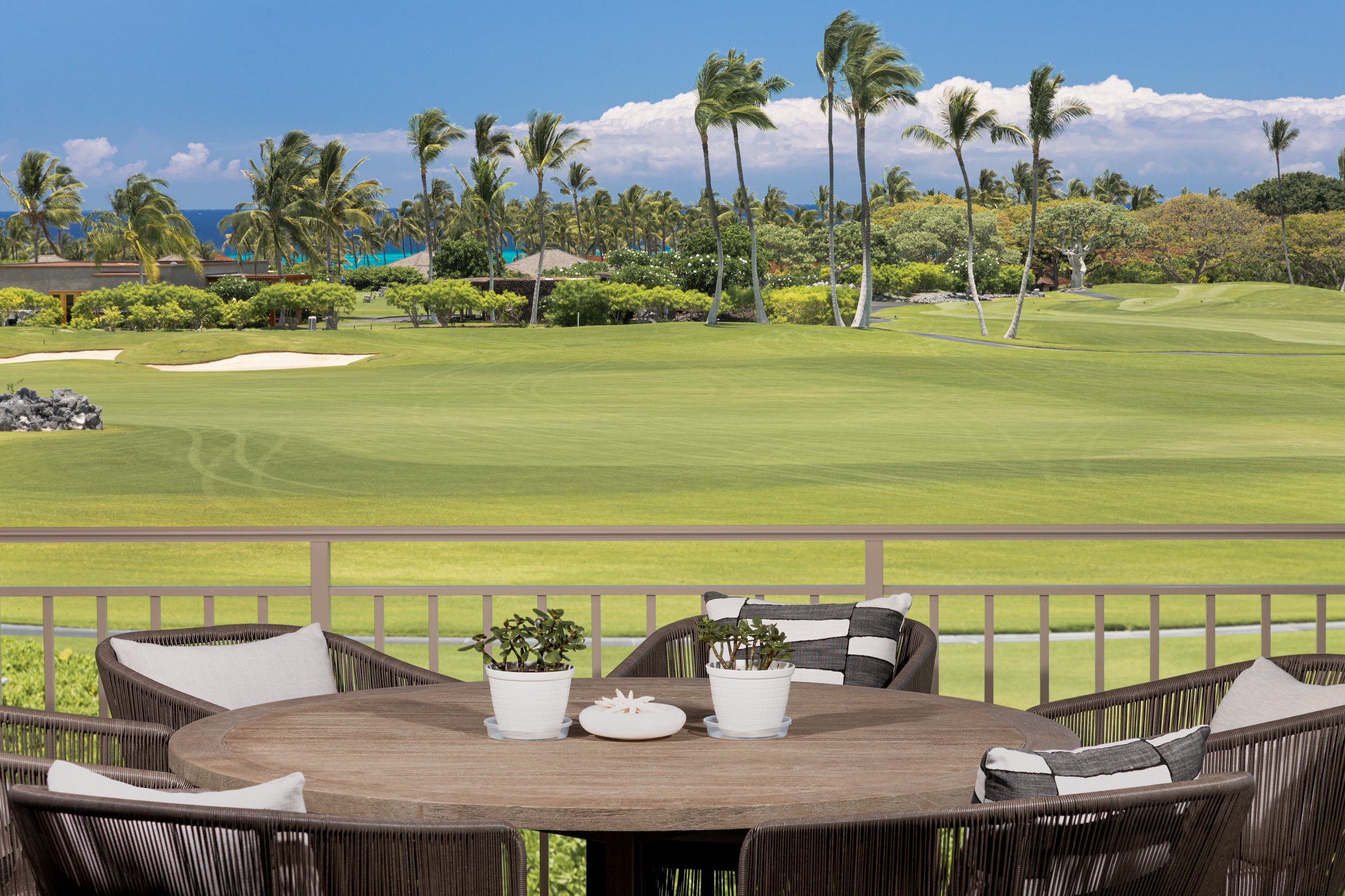 Covered lānai offers elevated ocean views over the 15th fairway of the Hualālai Golf Course.