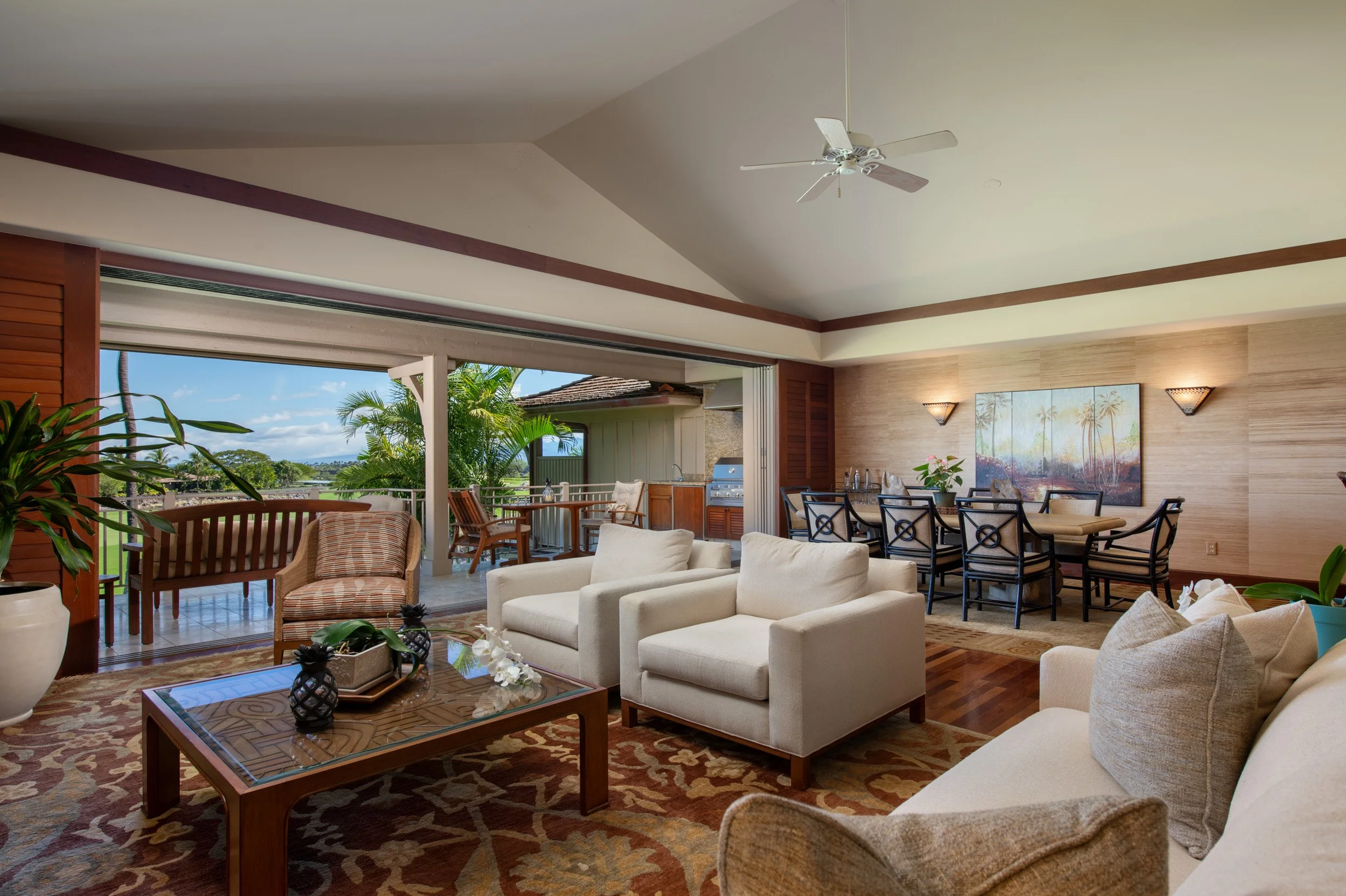 The spacious open floor plan extends to the lanai through pocketing doors, providing views of the golf course, Pacific Ocean, and the island of Maui.