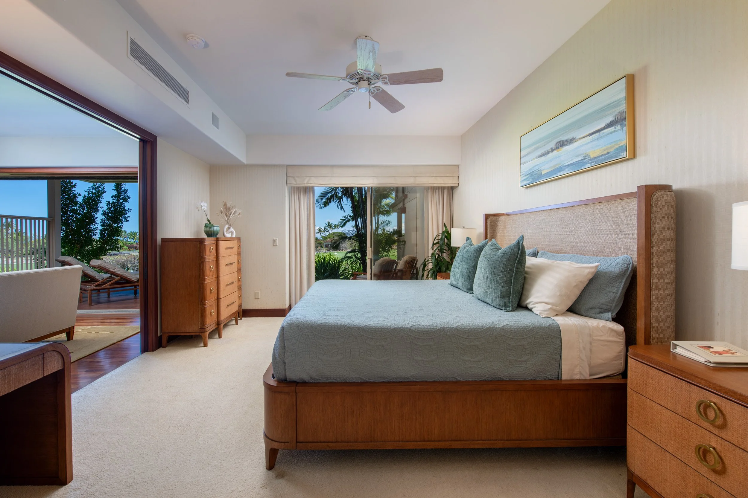 Spacious primary bedroom suite with walk-in closet, extended lanai, and full ensuite bathroom.