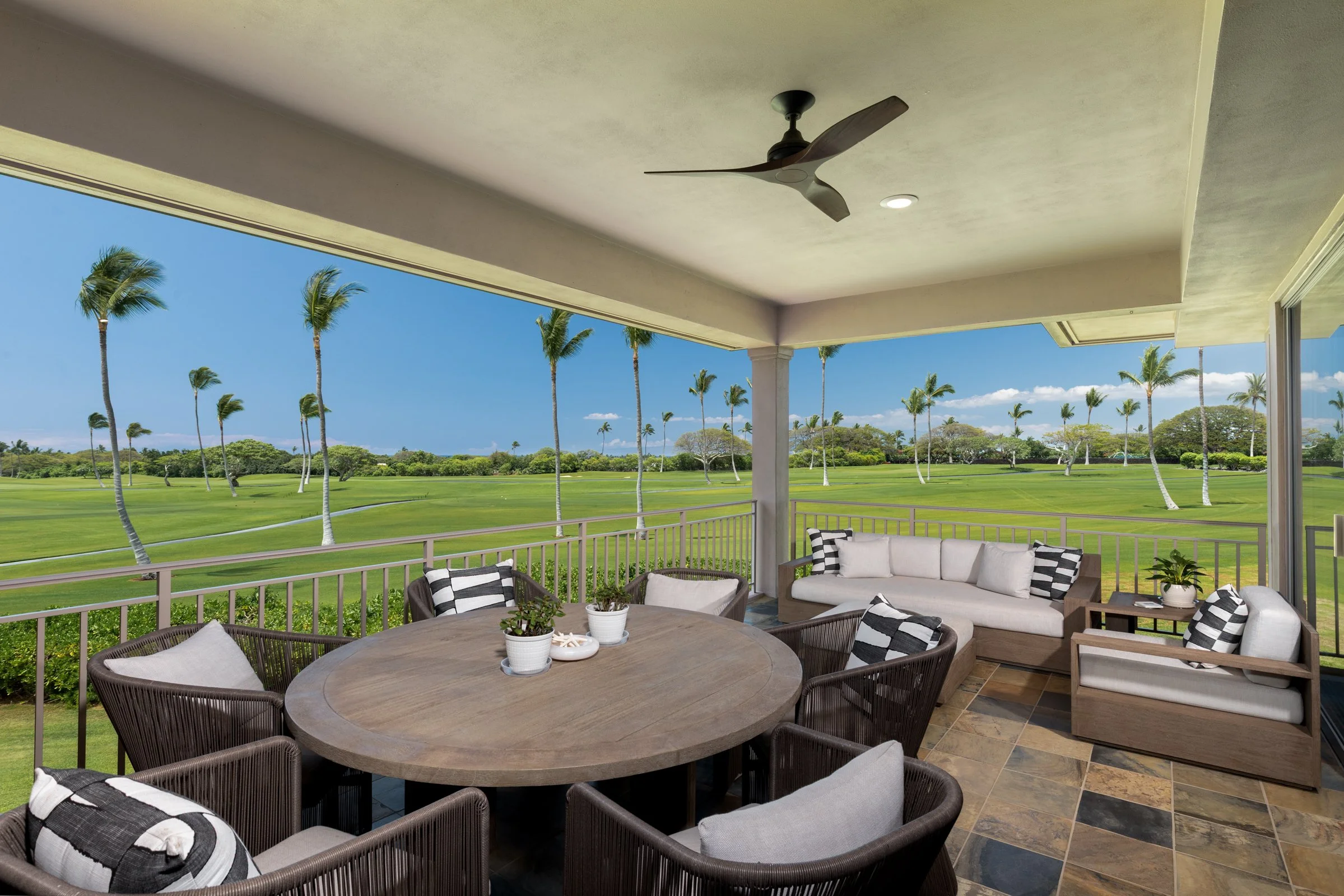 Sweeping Hualālai Golf Course views are enjoyed from the expansive outdoor lanai.