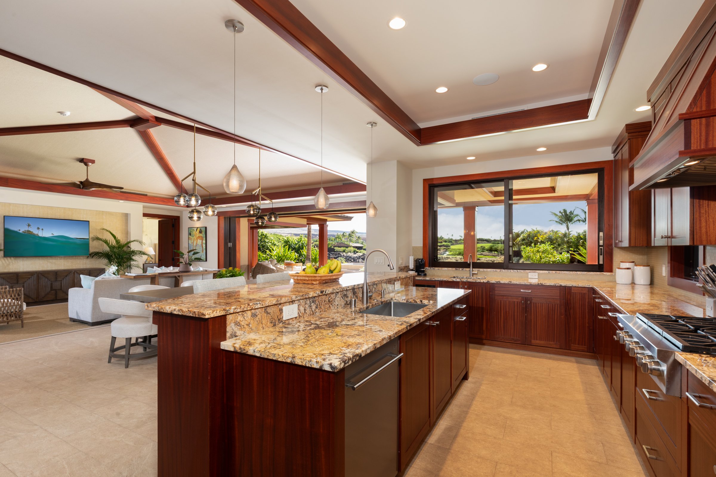 Kitchen features streamlined Wolf appliances, wine chiller, granite countertops, and mahogany cabinetry.