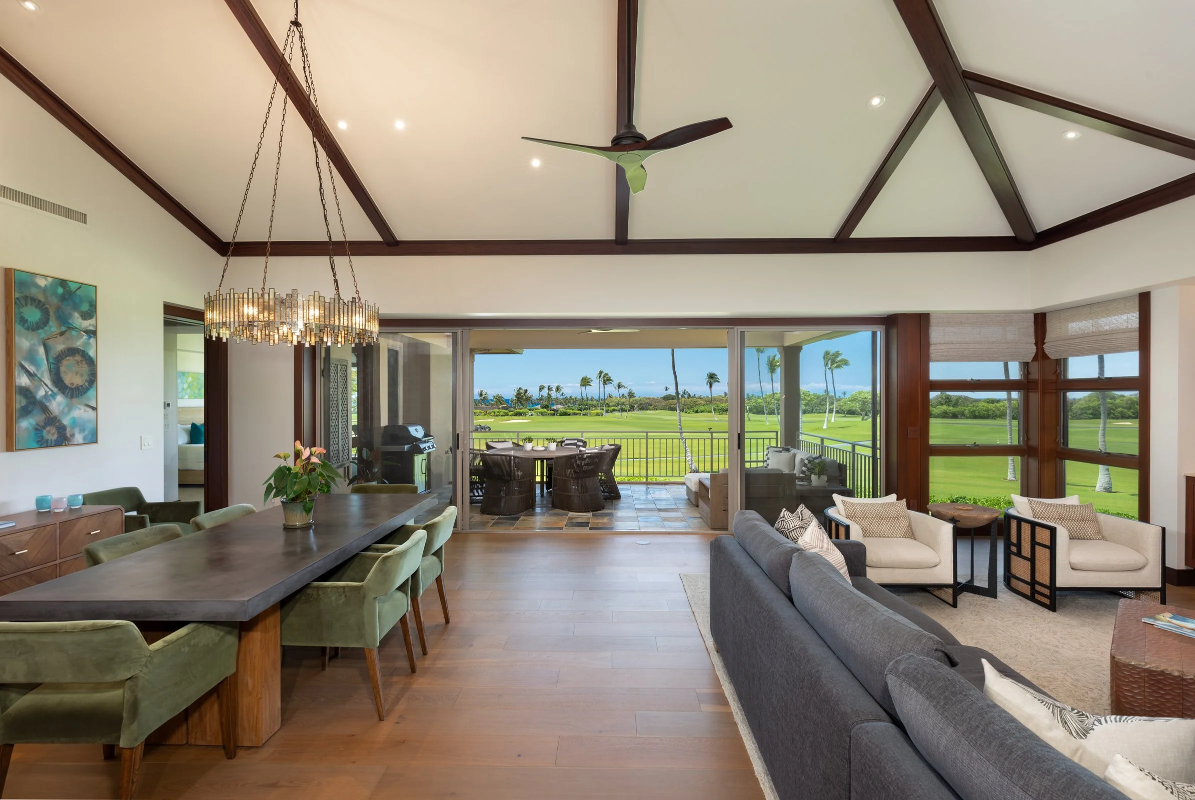 Open floor plan maximizes the great room and dining area, which seamlessly expand out onto the covered lānai.
