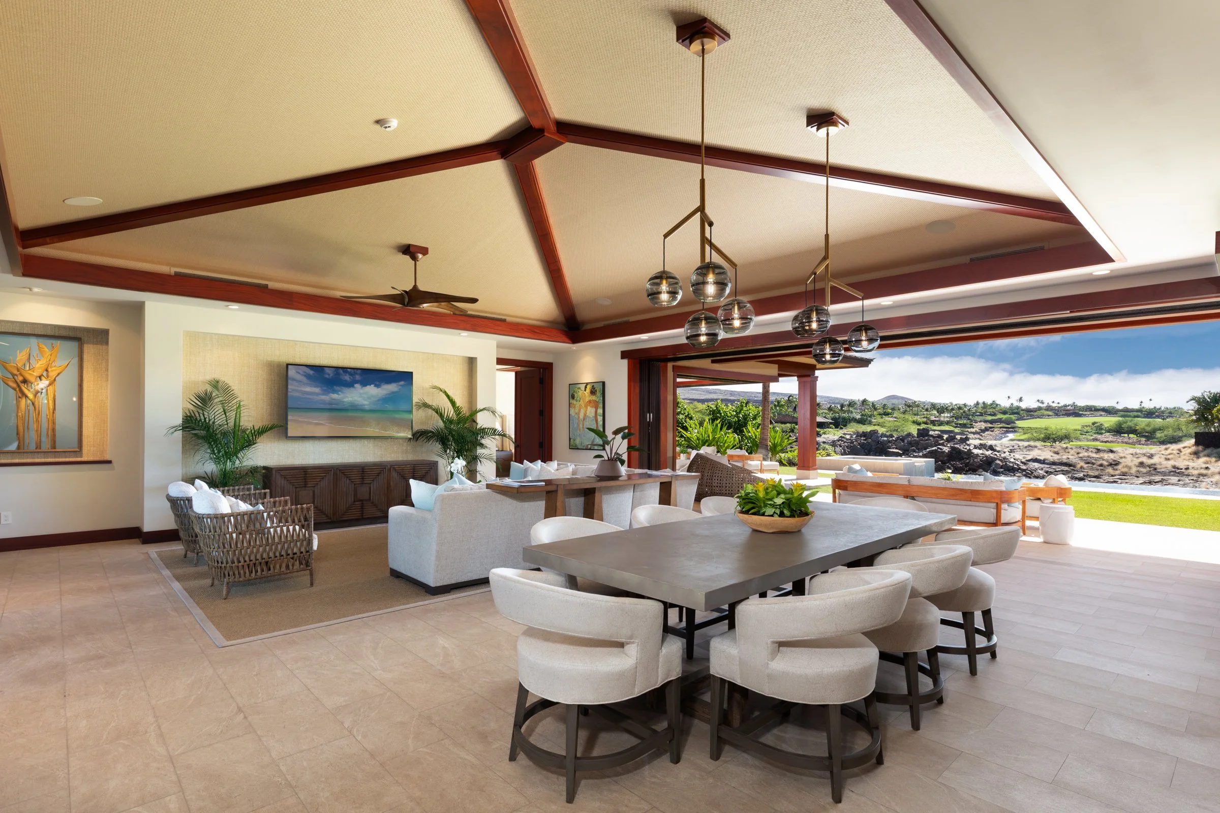 Spacious open floor plan provides seamless transition from the great room to dining and offers vaulted ceilings with mahogany trim and cove lighting, complemented with a light color pallet by designer, Gina Willman.