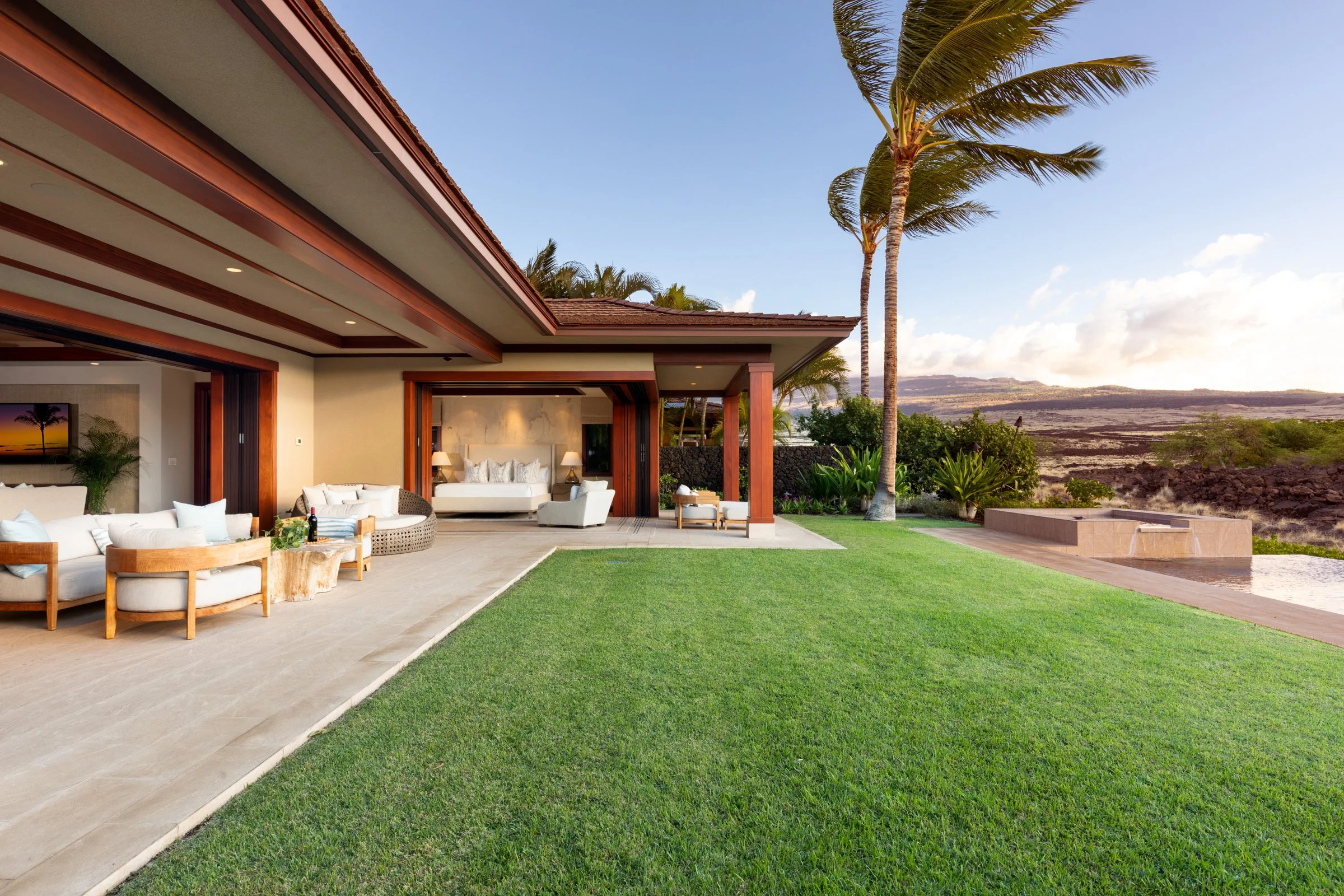 Seamless indoor – outdoor living space leading out to the covered lanāi and lush lawn.