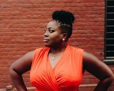 A woman with tightly curled hair