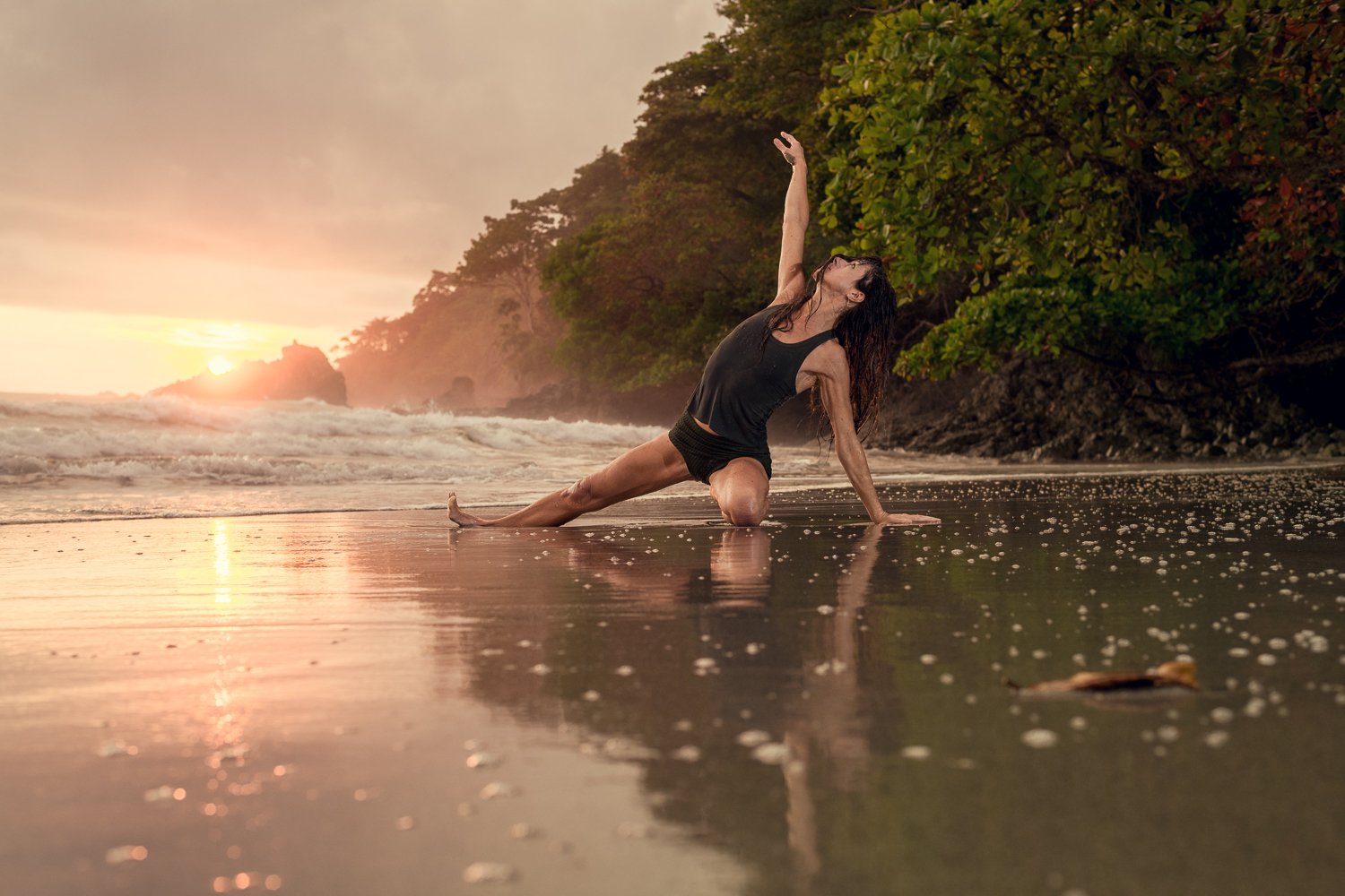 Jean Hall practising yoga on the beach, demonstrating mobility and flexibility
