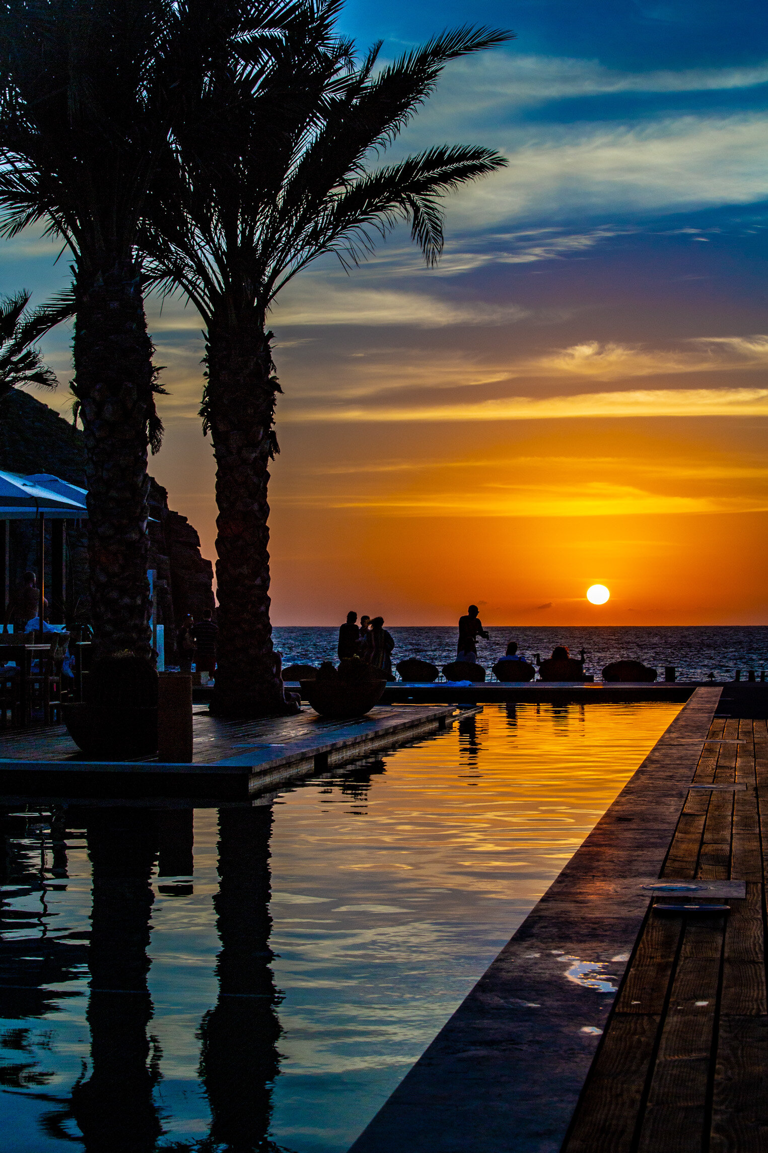 mexico resort sunset pool with palm trees