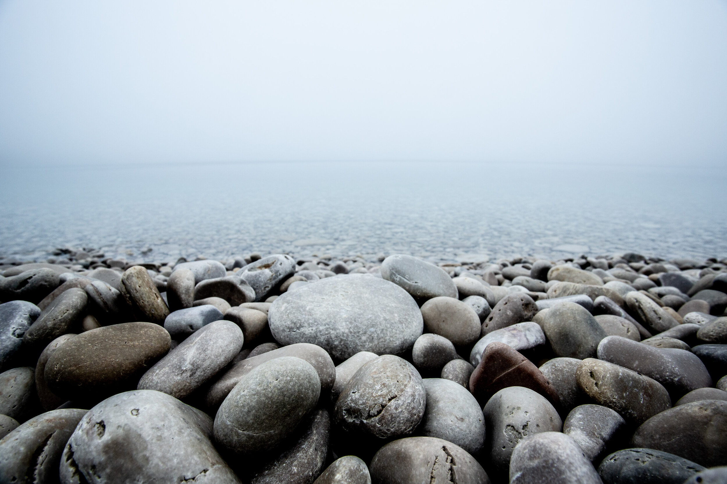 smooth stone beach in fog