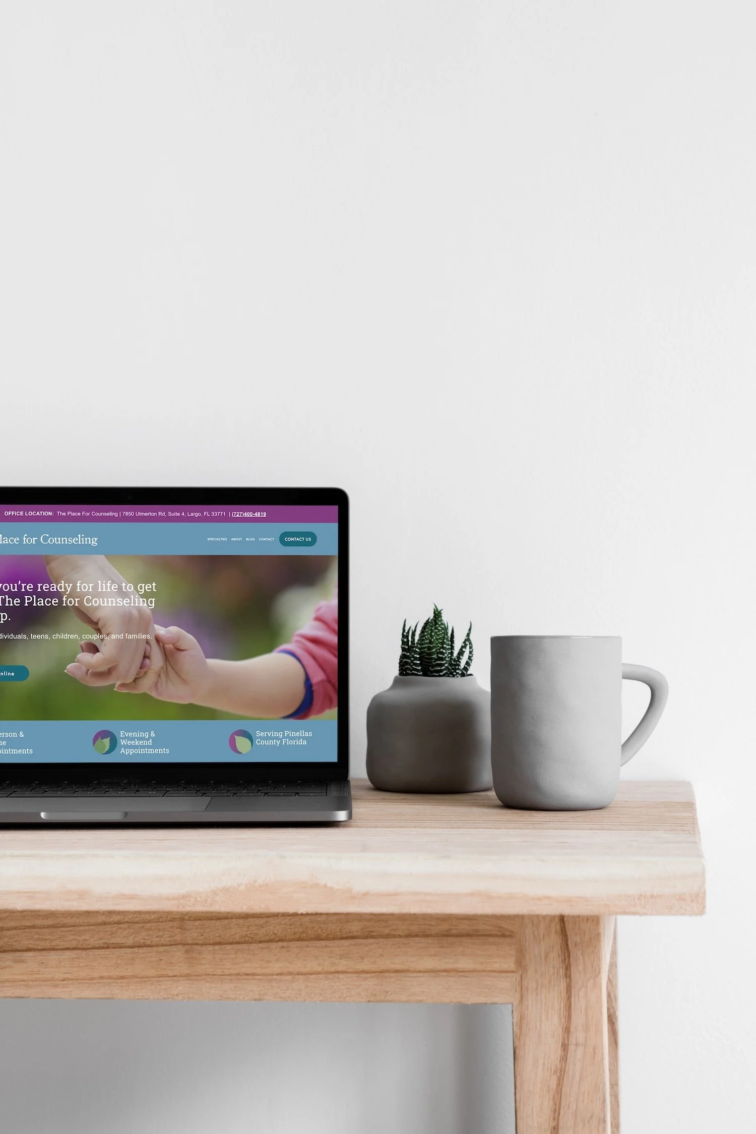 Website for a therapist sitting on a desk.