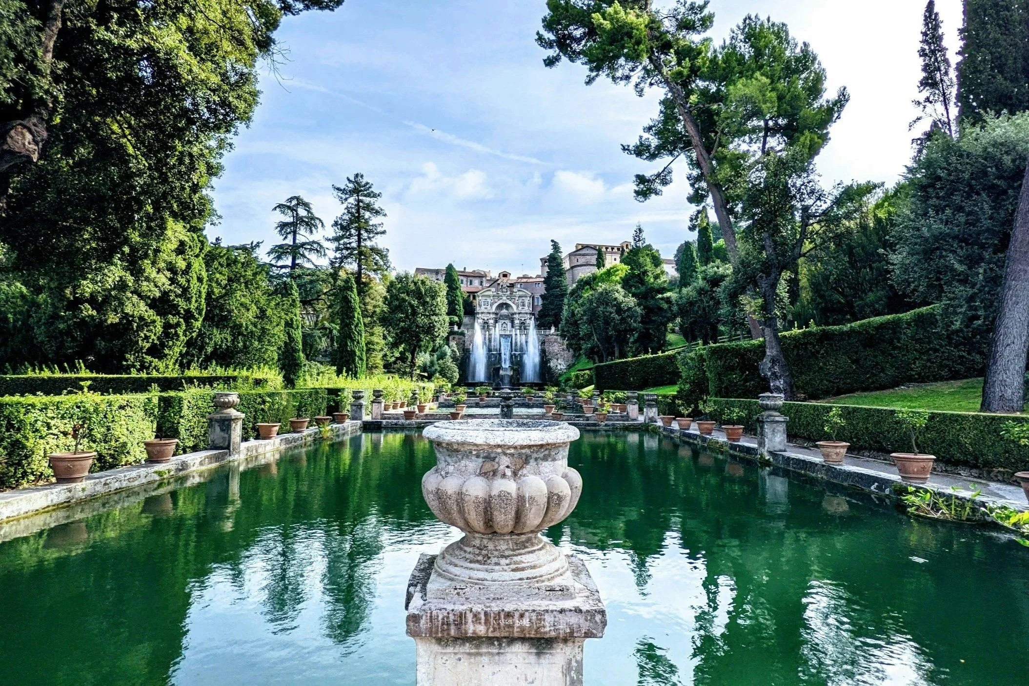 Symmetrical reflection ponds and dramatic water fountains surrounded by lush Renaissance gardens at Villa d’Este in Tivoli, Italy.