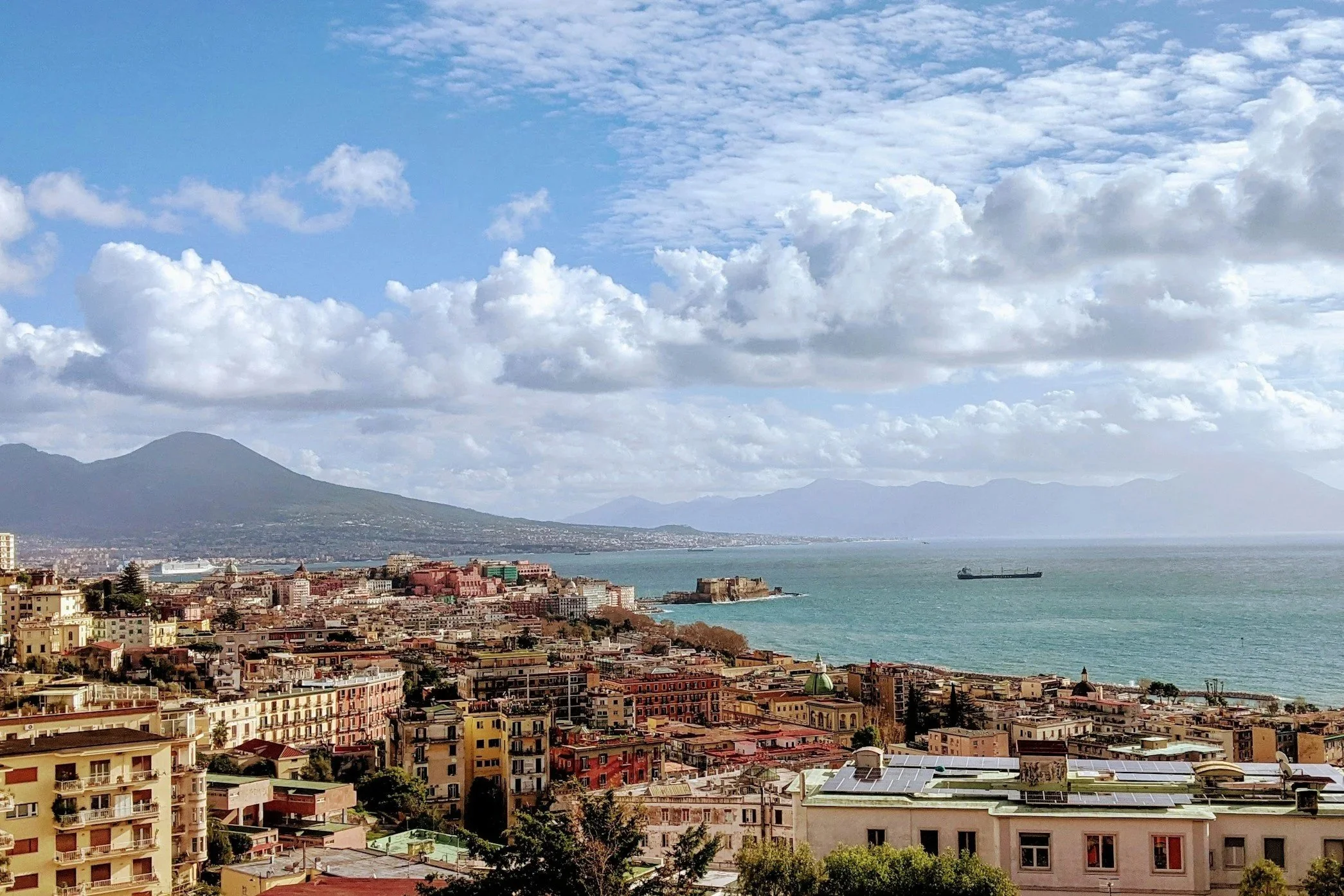 Panoramic view of the city of Naples with Mount Vesuvius and Castel dell'Ovo along the Gulf of Naples.