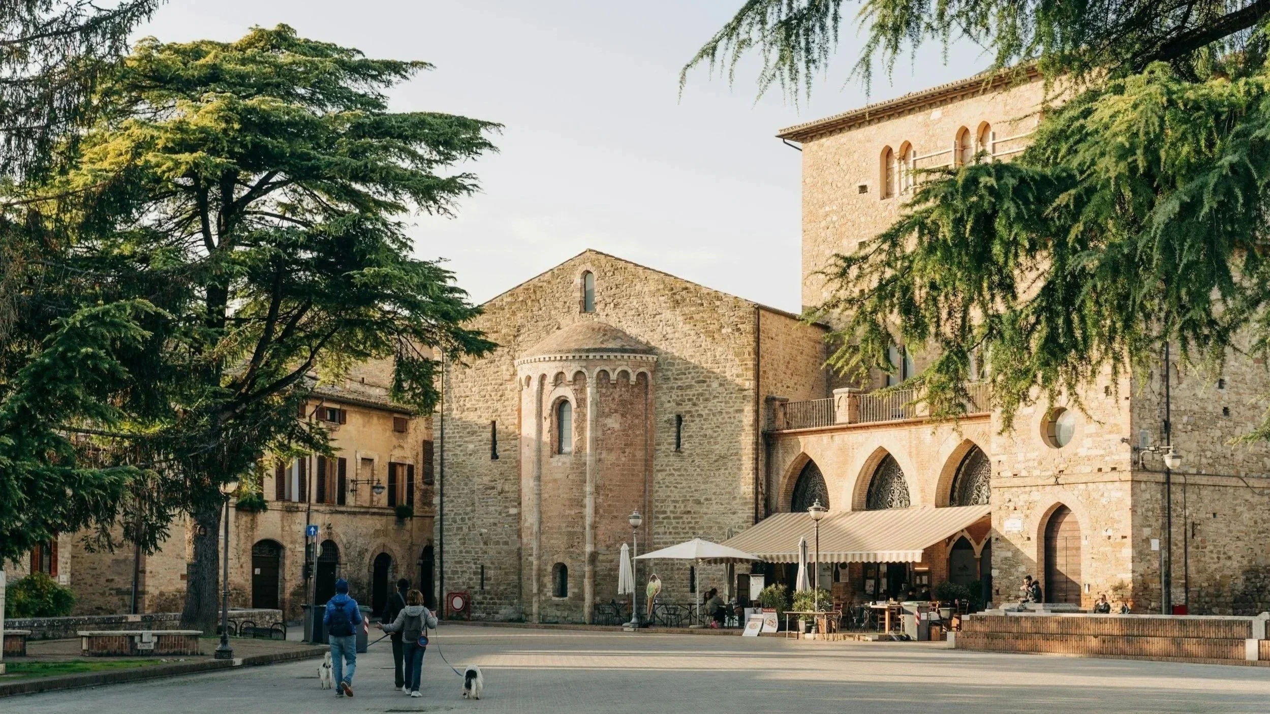 Morning light over the Romanesque apse of San Silvestro and the medieval Palazzo dei Consoli in Piazza Silvestri, Bevagna, Umbria.
