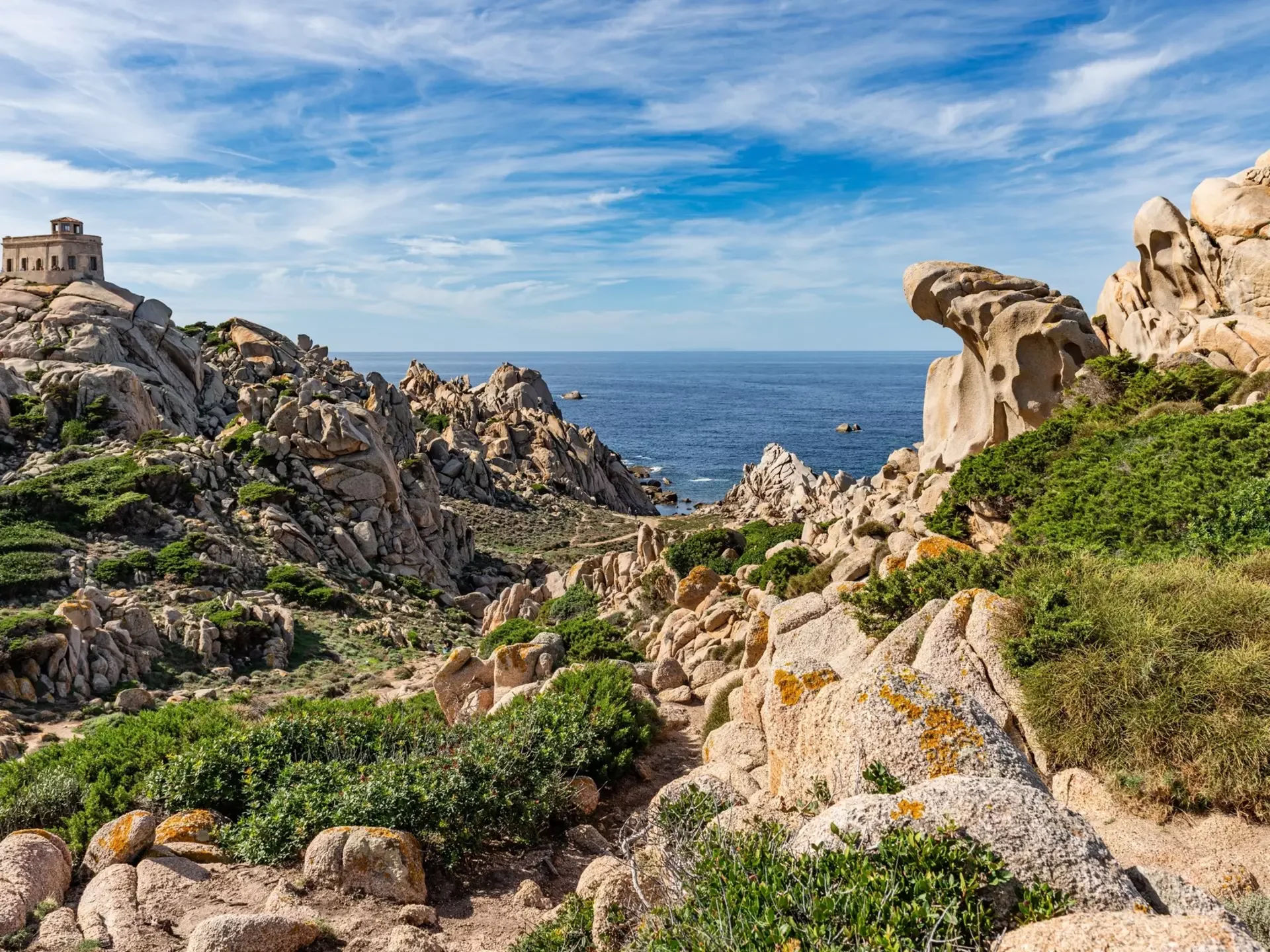 Dramatic wind-sculpted granite rock formations and Mediterranean maquis surrounding Valle della Luna at Capo Testa in the Gallura region of northern Sardinia.