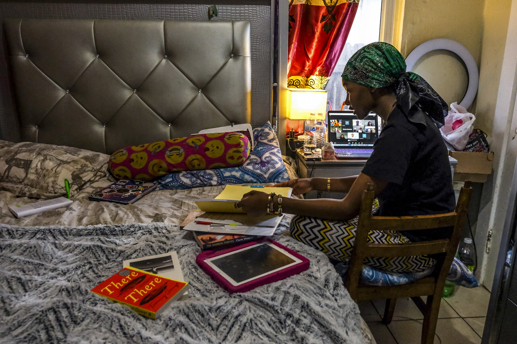  USA, San Diego, CA, November 5, 2020. &nbsp; In the bedroom that she shares with her children, Musa sorts through notebooks and class materials for her UCSD indigenous literature course. With two elementary school children of her own, Musa also navi