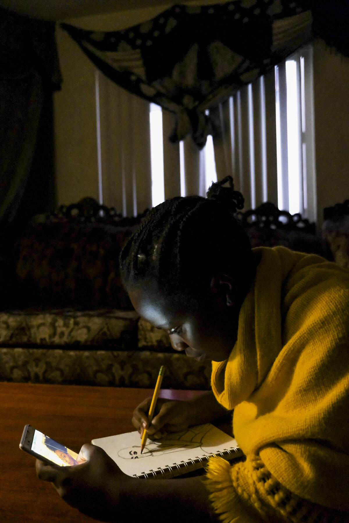  USA, San Diego, CA, October 26, 2020. Mwanini Shabani, 15, draws a model from her Instagram feed. Shabani says art is her escape but doesn’t show many people. After finishing homework, she often draws from 7 to 11 p.m. The International Rescue Commi