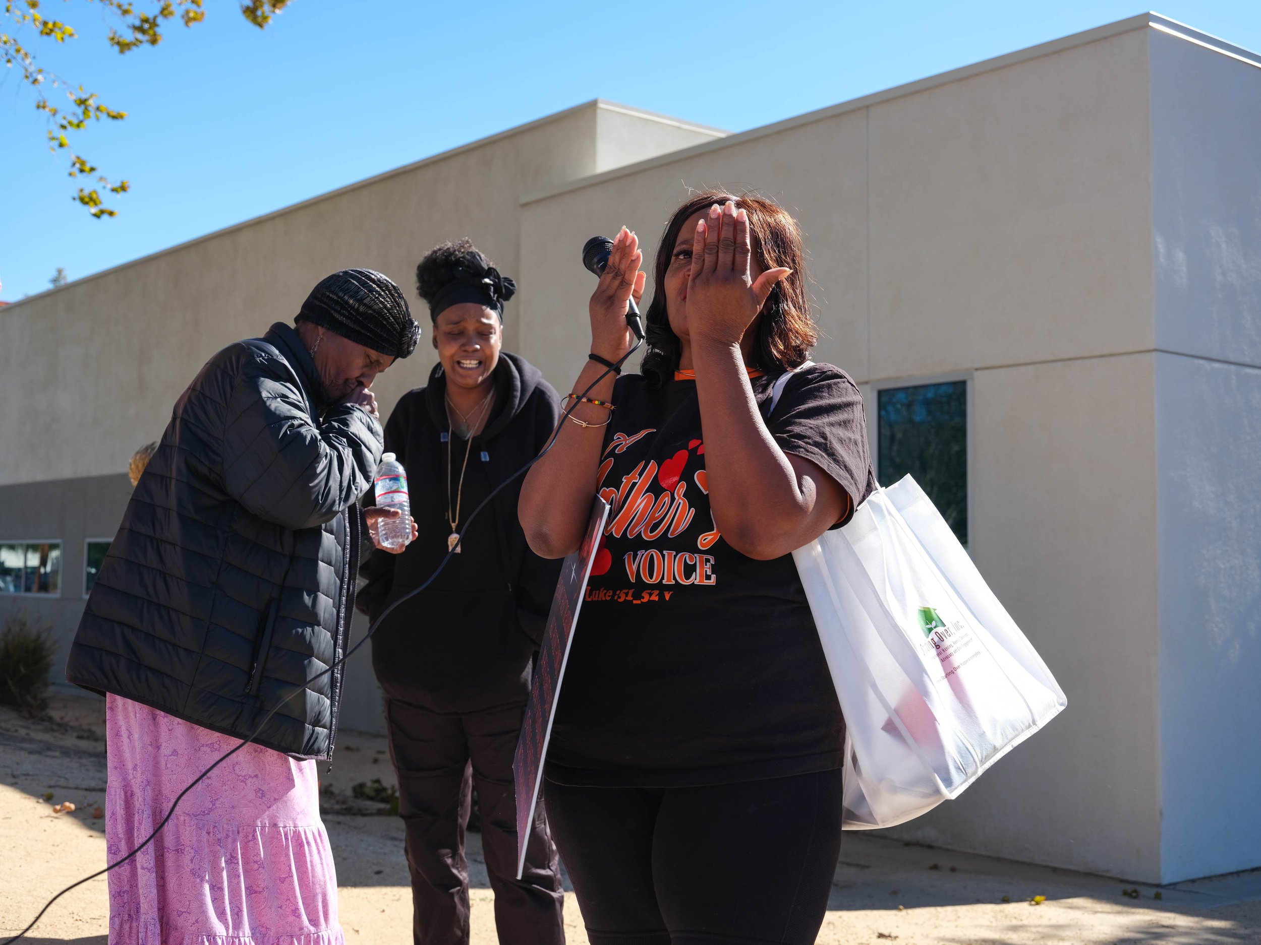  A family begins to cry as Yvonne Trice (right), founder of A Mother’s Voice, leads the group of protesters in a prayer outside of the San Bernardino Juvenile Justice Court on November 16, 2022. The family was leaving the Juvenile Court when they enc