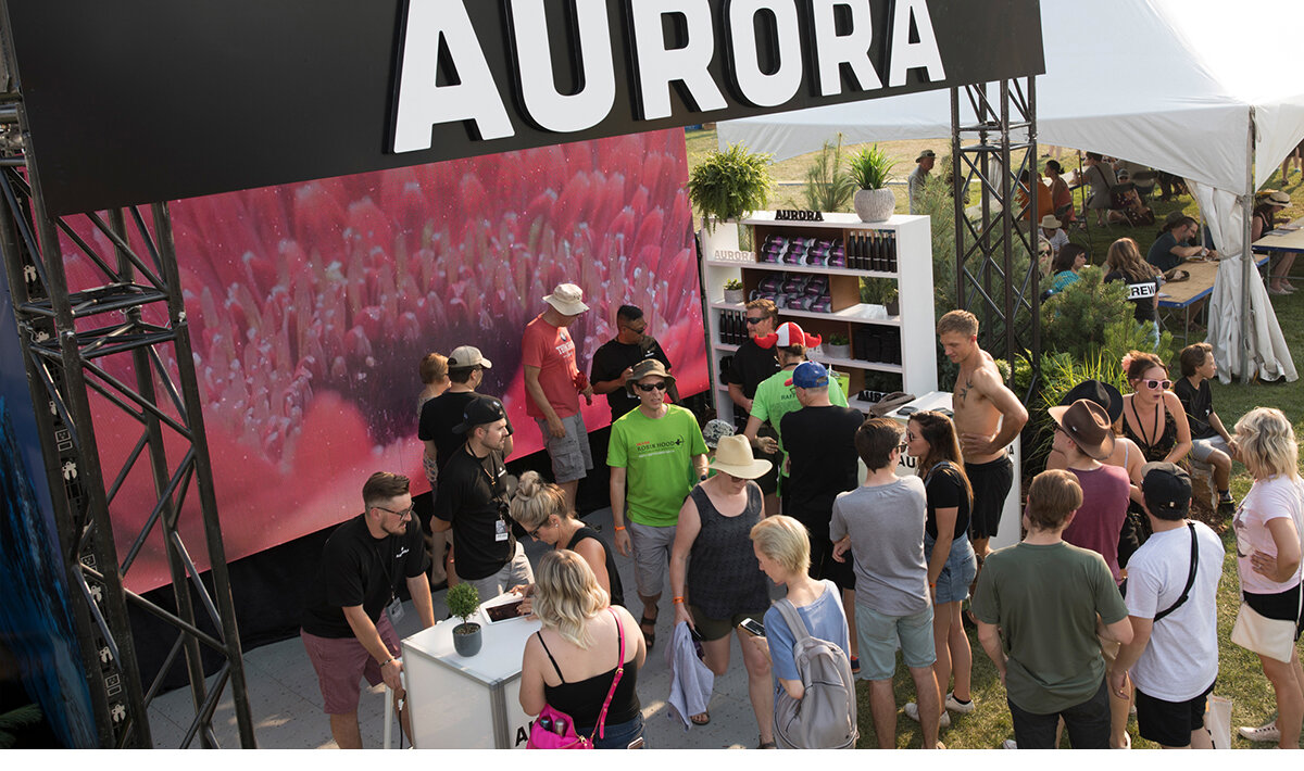Brand ambassadors chatting with multiple festival goers at the Aurora Cannabis brand activation in Edmonton, Alberta, Canada