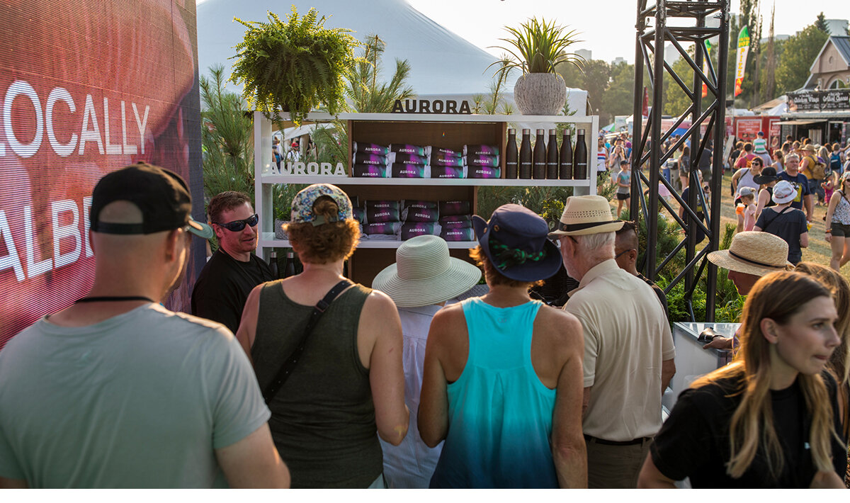 Multiple people purchasing products at the Aurora Cannabis brand activation at a festival in Edmonton, Alberta, Canada