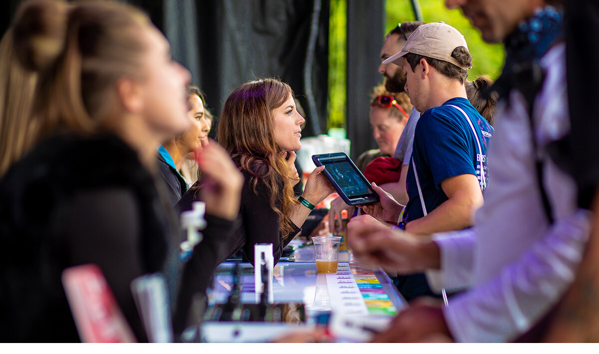 Brand ambassadors signing up festival attendees during a sampling program at the Skookum Music Festival in Vancouver, B.C.