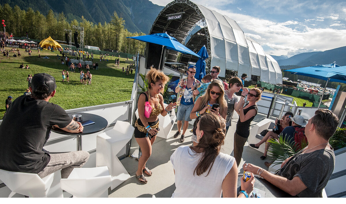 Festival goers enjoying the view from the VIP terrace on the Blue Lounge brand activation 
