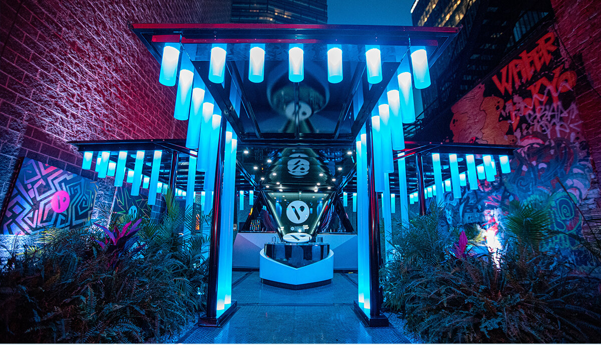 Vuse experiential marketing brand activation with neon blue LED tubes illuminating the structure 