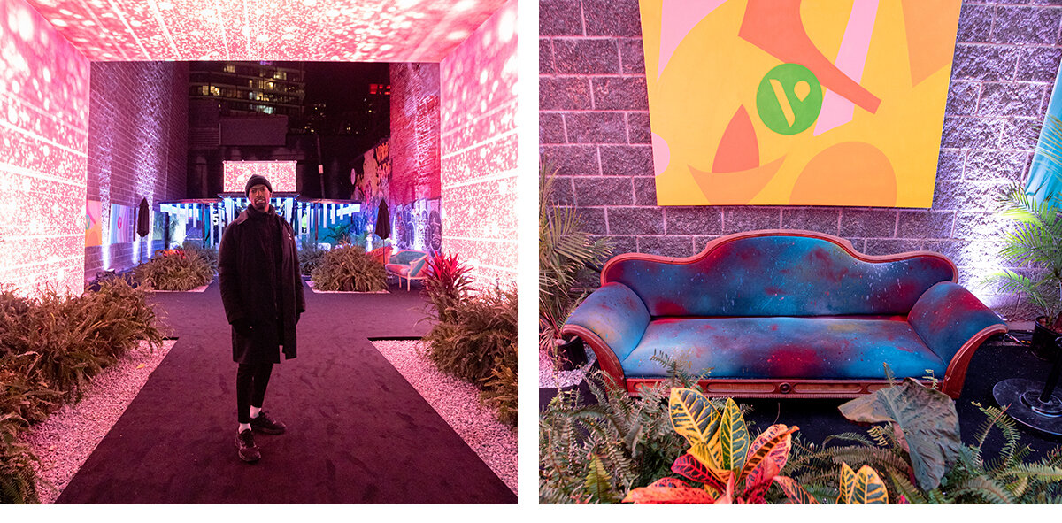 Black man wearing all black clothing inside Vype brand activation in downtown Toronto surrounded by LED lights, neon blue couch and local artwork on the walls, all in oasis garden