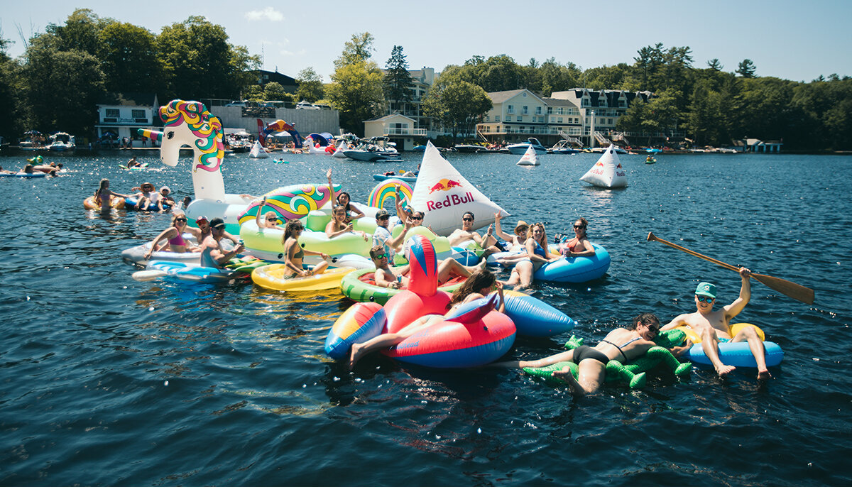 Multiple weekend cottagers on branded Red Bull floaties at Red Bull Open Water brand activation.