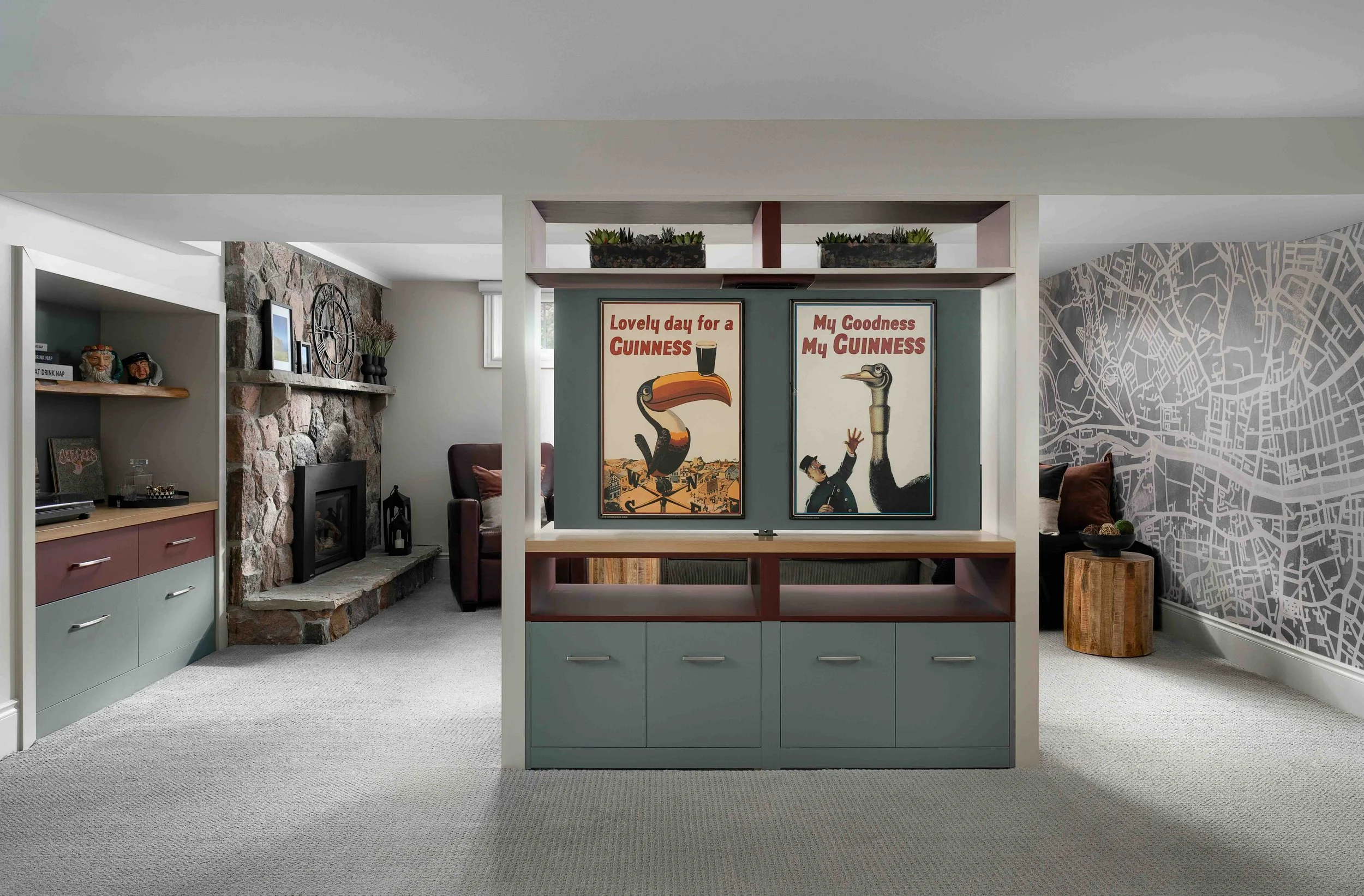 Custom basement media wall with built-in cabinetry and framed artwork display in a modern King City home renovation.