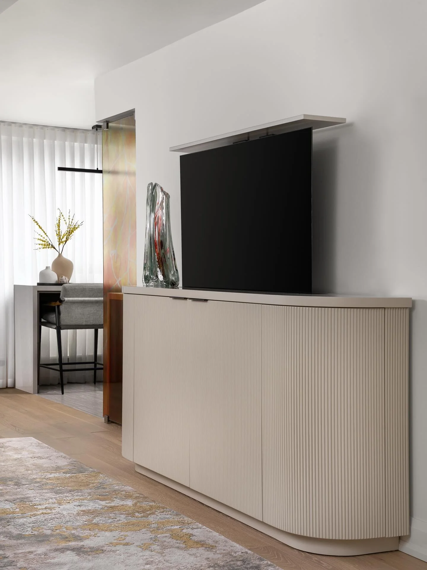 Technology does not always need to be on display. This custom credenza integrates the TV into the design, allowing it to disappear when not in use. With a shy technology approach visual clutter is reduced and a composed space is created!

Photography