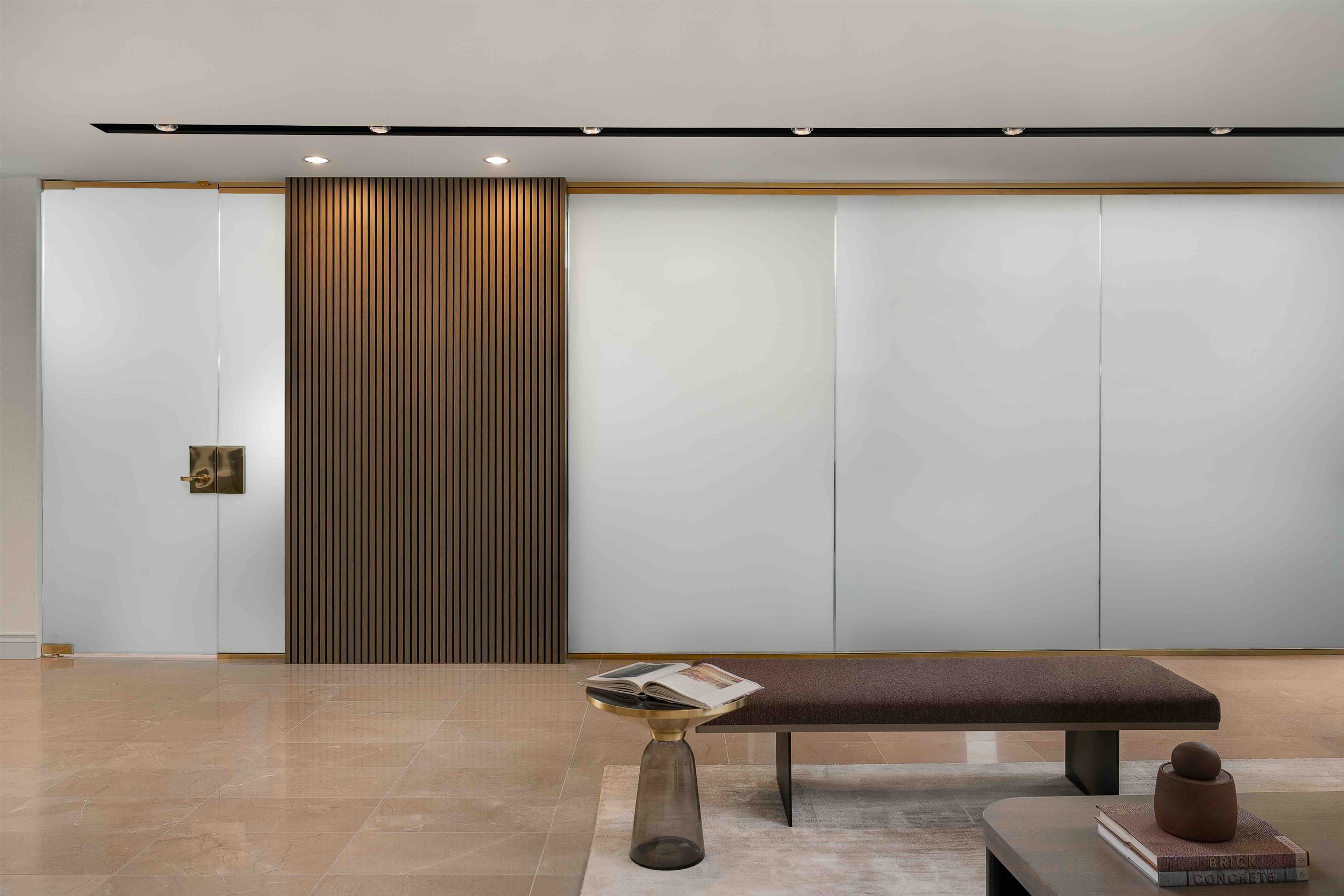 Modern office lobby with glass privacy wall and wood slat feature panel