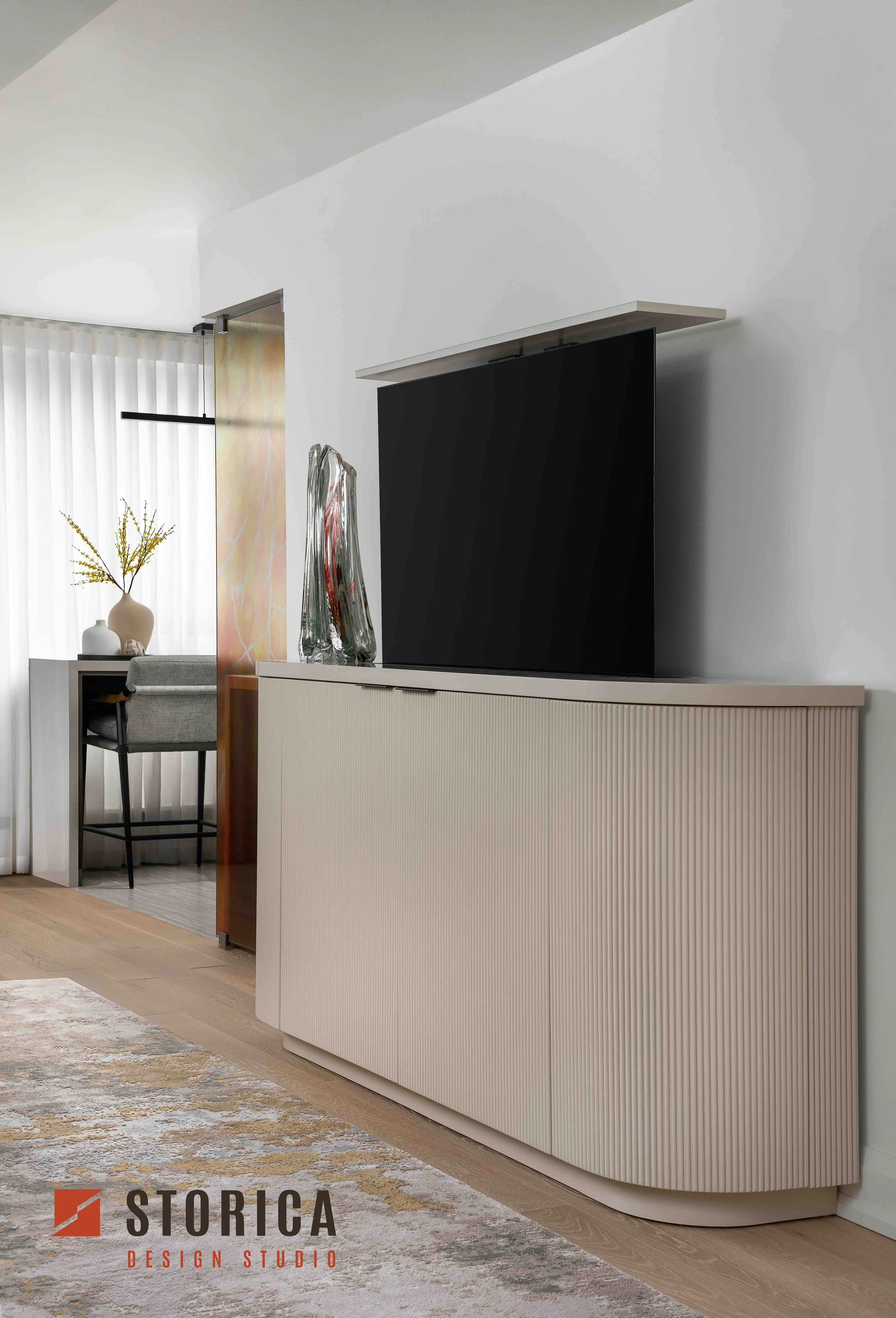 Modern condo console with TV lift, fluted cabinetry and minimalist media wall design.