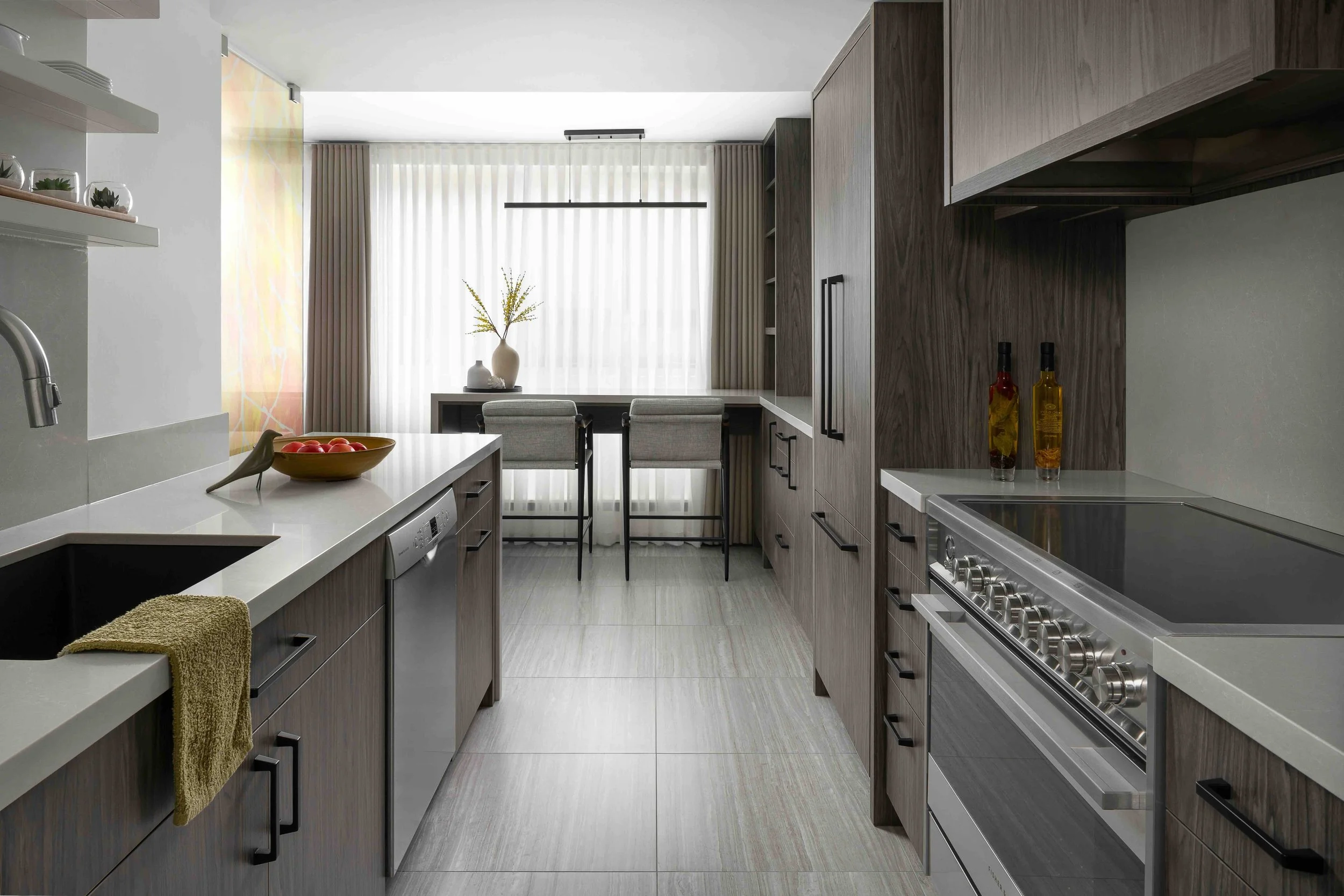 Modern condo galley kitchen with custom cabinetry, quartz countertops, and integrated breakfast bar.