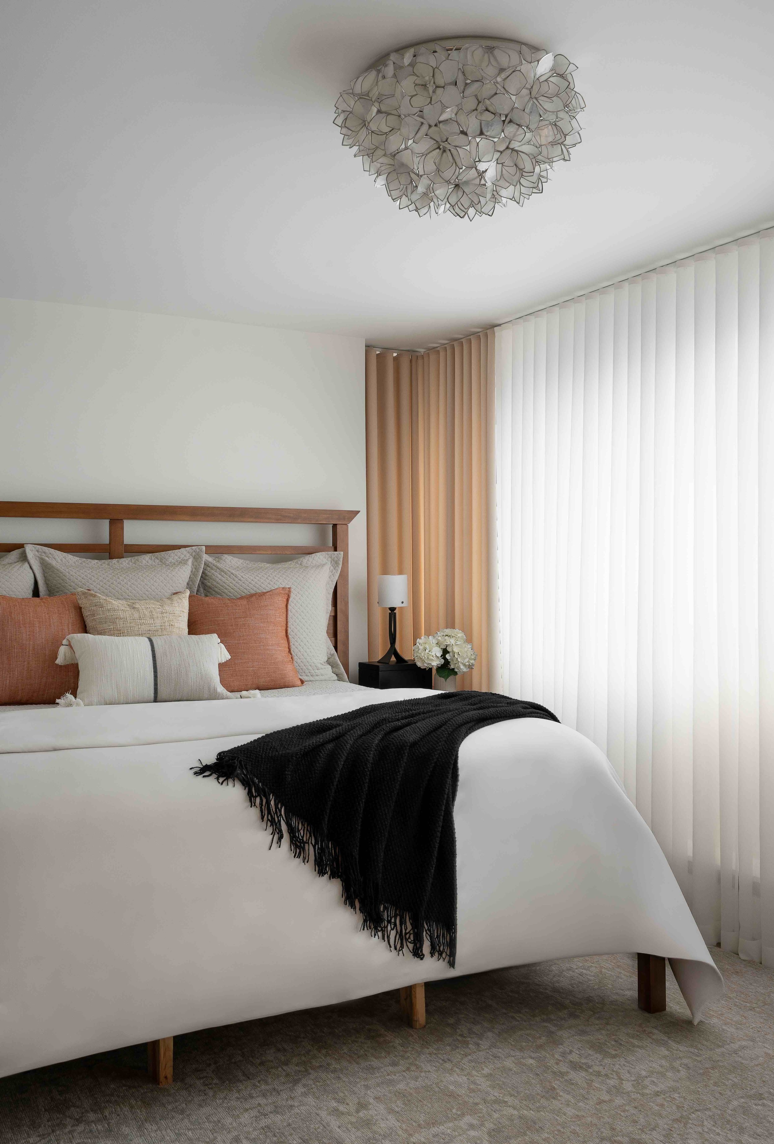 modern primary bedroom update with custom bedding and drapery