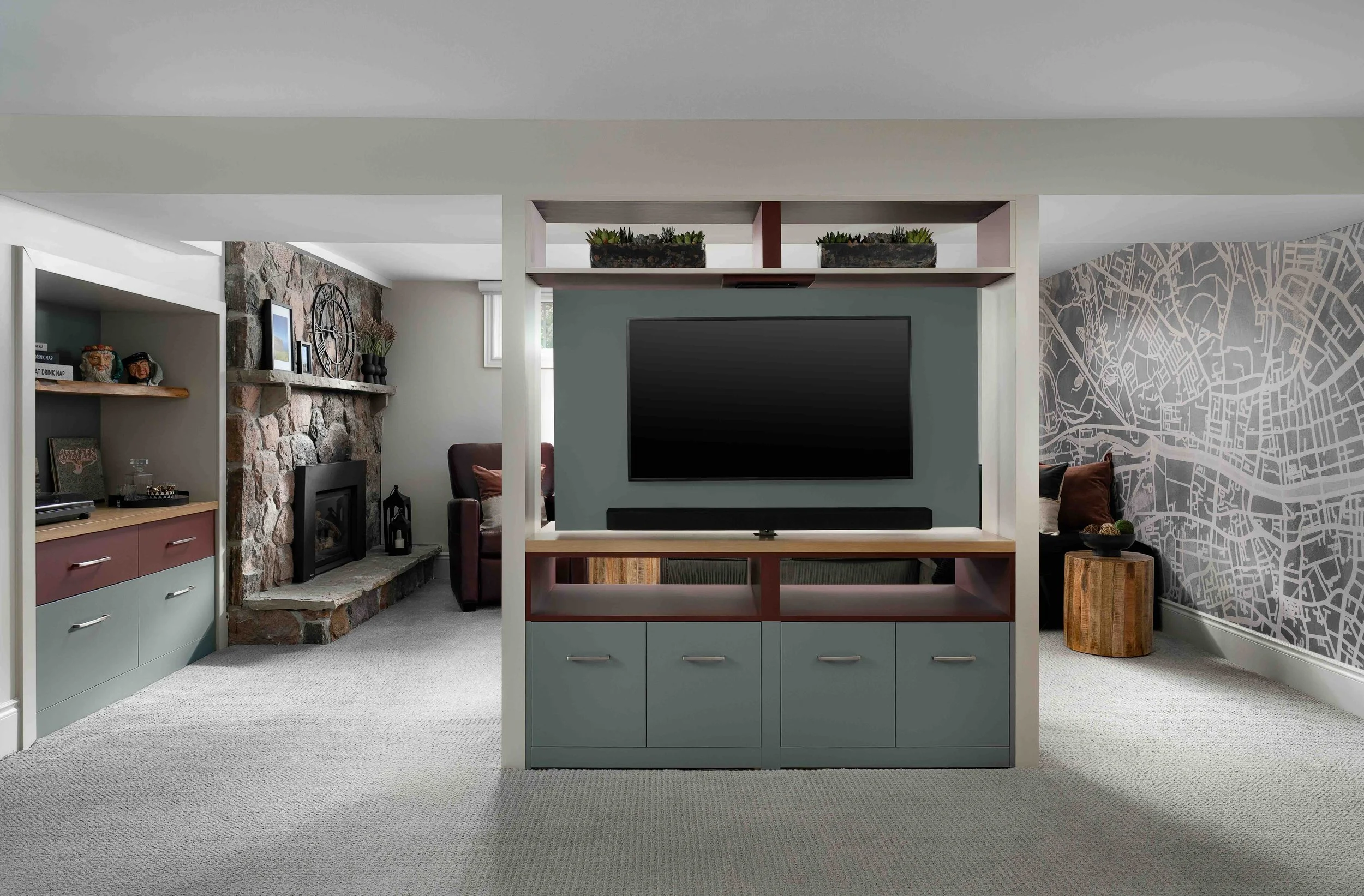 Custom basement media wall with built-in cabinets and TV in a modern King City home renovation.