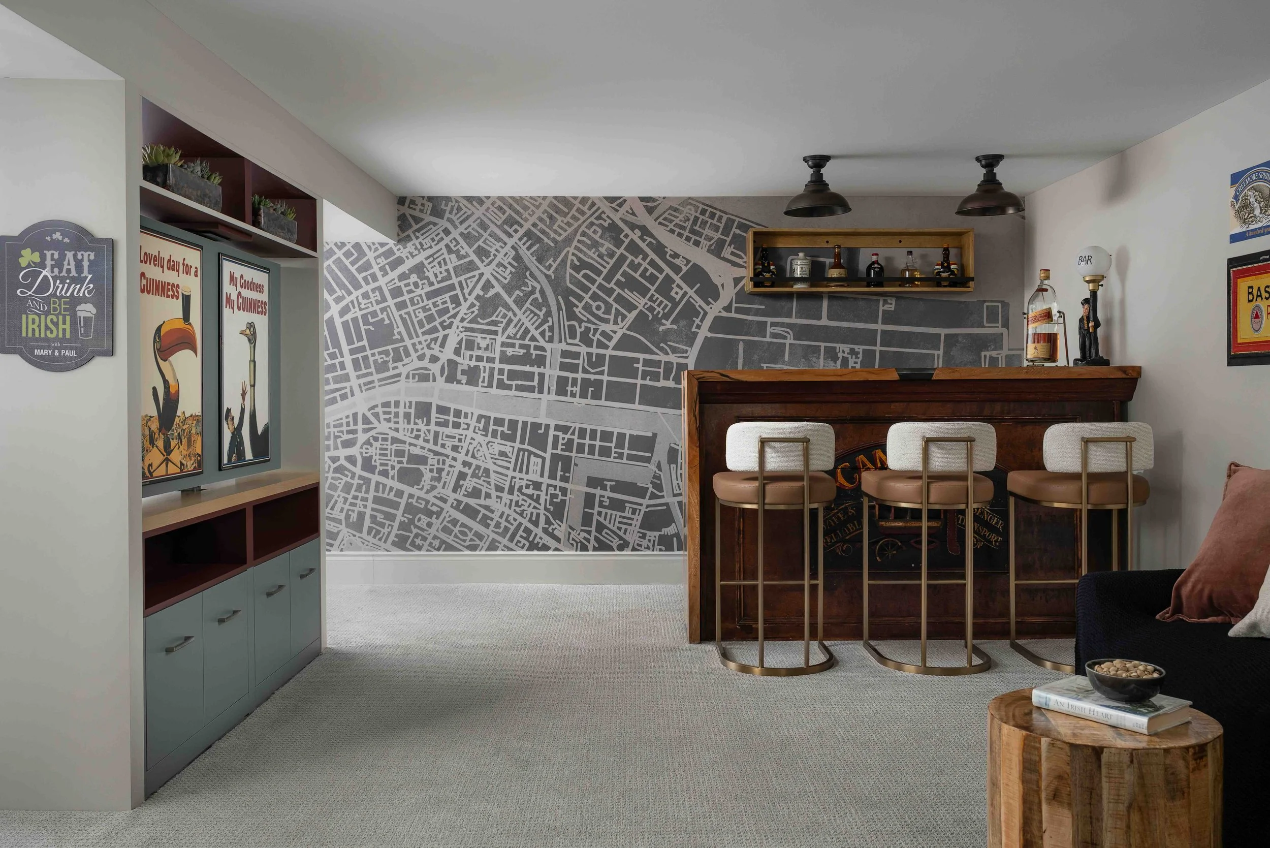 Basement entertainment area with custom bar, built-in cabinetry, and feature wall in a King City home renovation.