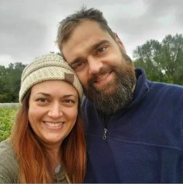 Jason Randall and his partner posing outdoors, both smiling.