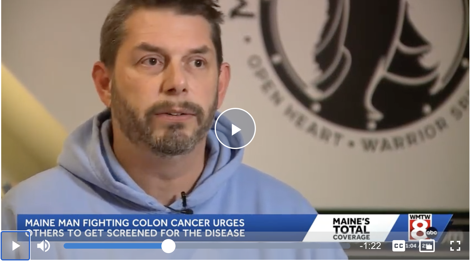 Video thumbnail from WMTW News 8 interview titled "Maine man fighting colon cancer urges others to get screened for the disease," showing a man in a blue hoodie in front of the Man Up to Cancer logo.