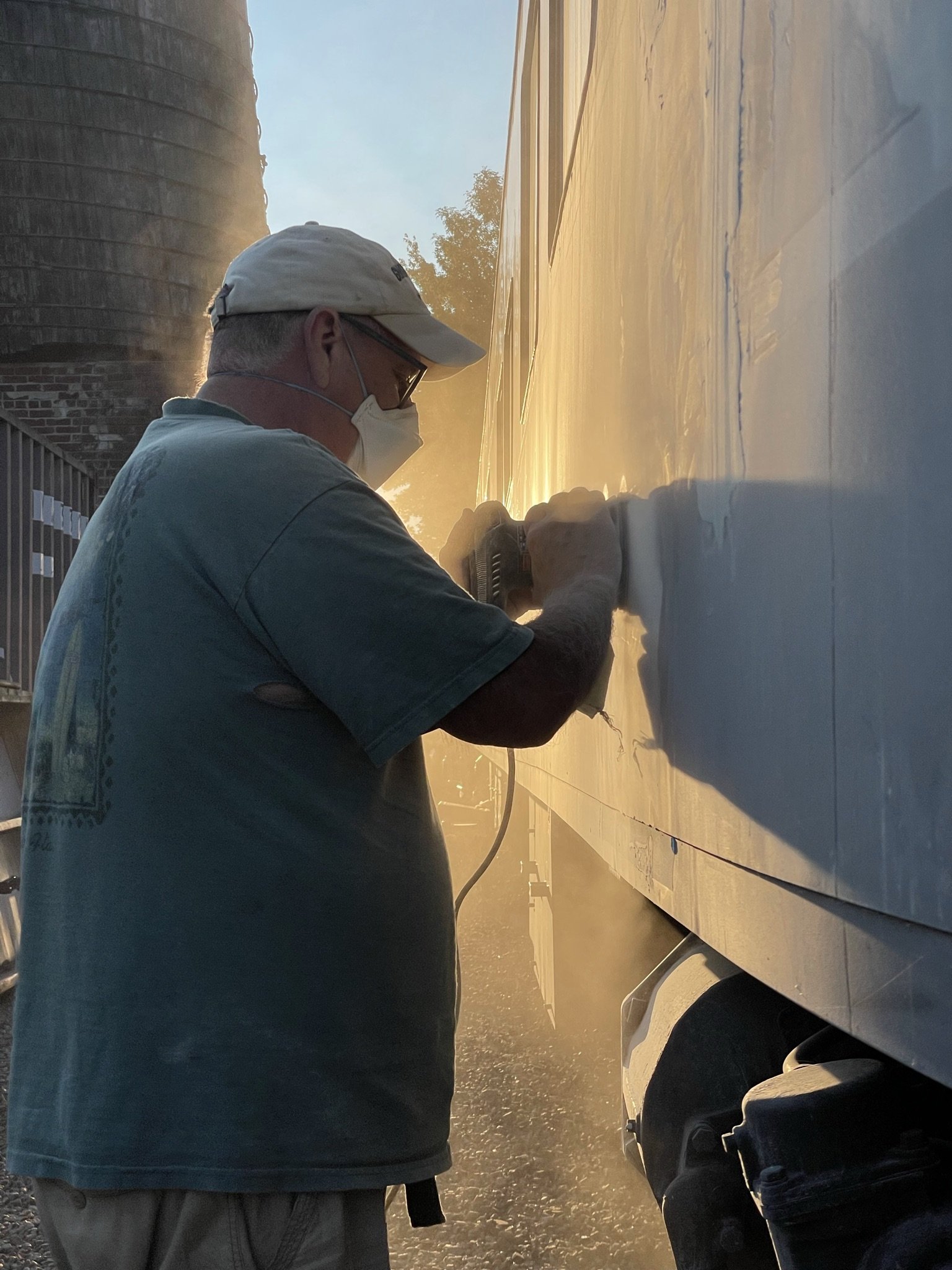 Volunteer Alan in the long, tedious process of sanding new body work smooth. 