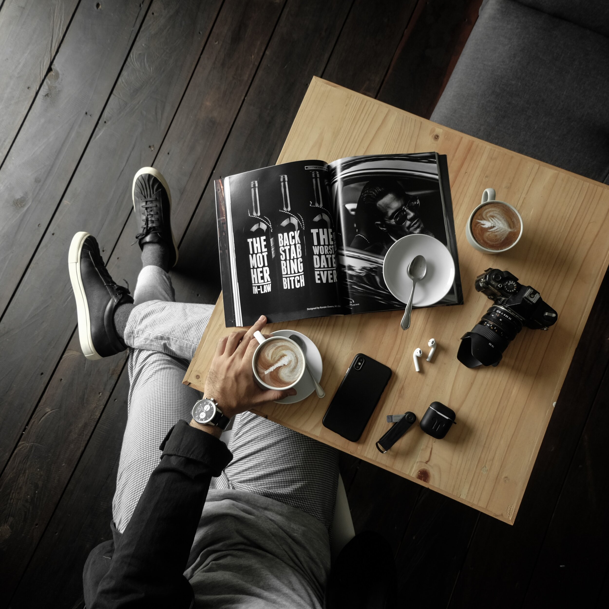 top-view-of-a-table-with-man-holding-a-cup-of-latte-with-a-3098619.jpg