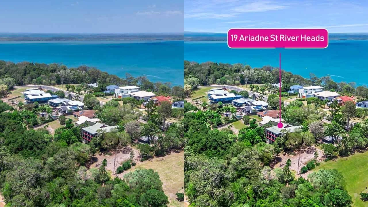 Aerial view of a coastal residential area with several modern houses surrounded by green trees, and a body of water in the background. The image highlights the location 19 Ariadne St River Heads with a pink label.