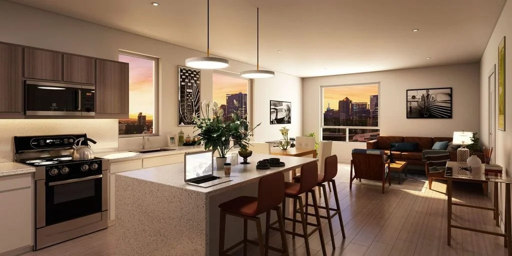 Open-concept apartment living space with kitchen and living room, looking at sunset views through large windows
