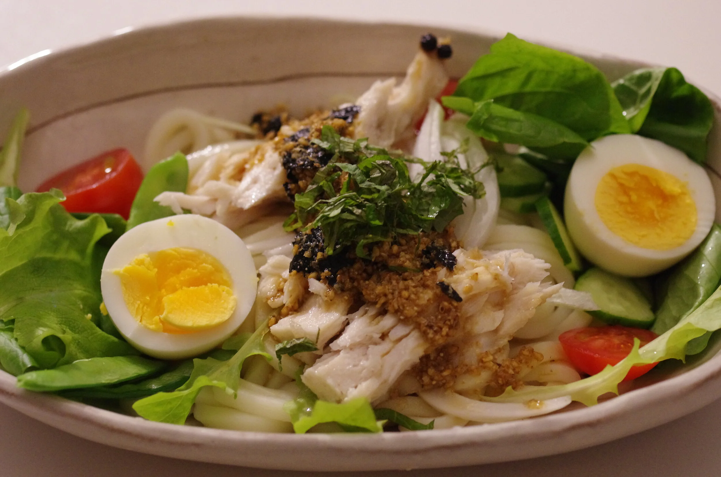 Udon salad with homemade tuna, boiled egg, vegetables with sesame dressing with Shiso