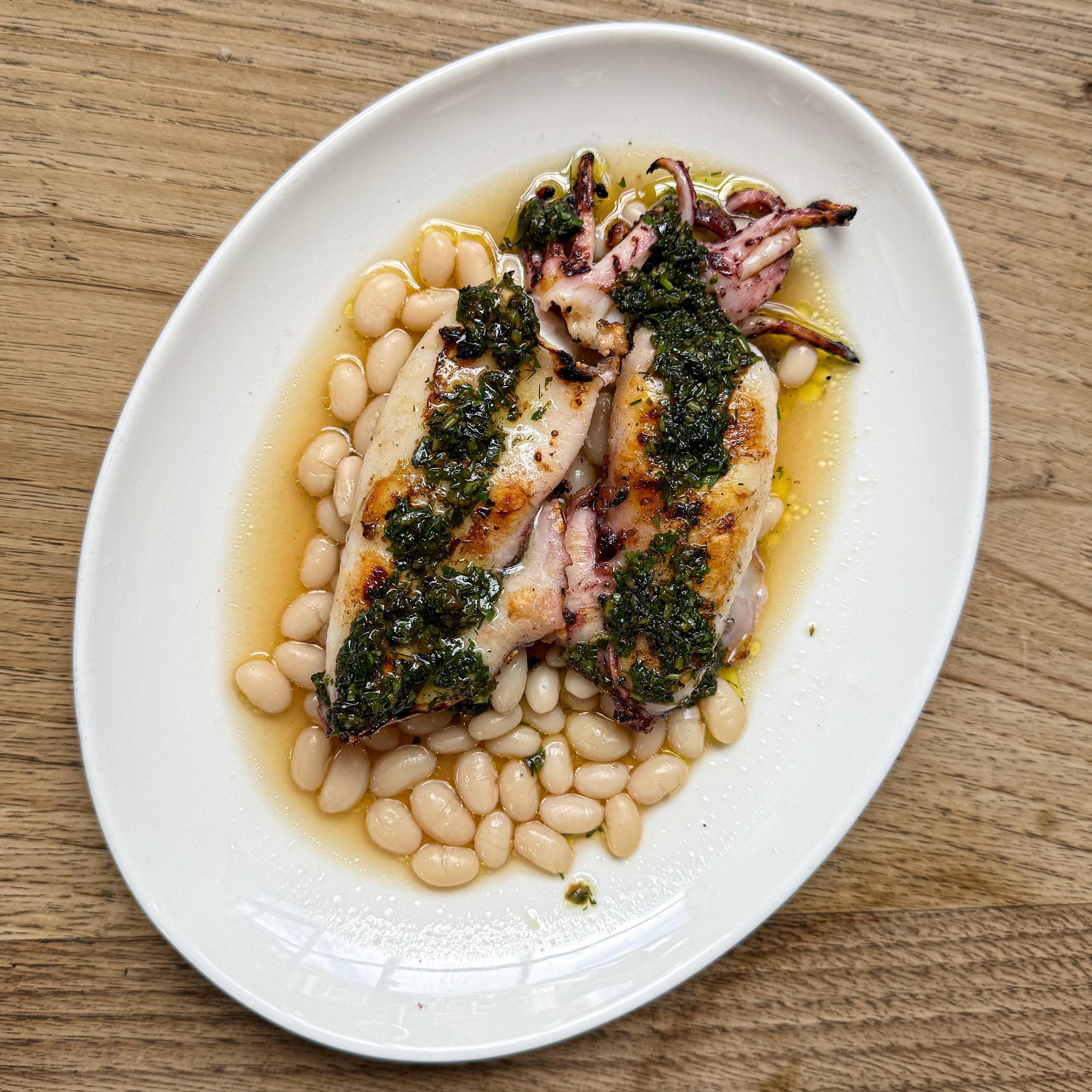 Squid and beans. At Michelin-starred &quot;Brat&quot; in Shoreditch. 
&mdash; 
#squid #brat #shoreditch #london  #onemichelinstar 
.
.
#mystorywithmichelin #michelinplate #michelinfood #delicious #eeeeeats #food #foodie #foodgasm #foodpics #foodporn 