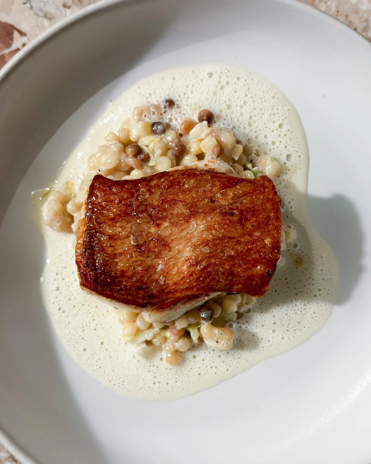 Crispy cod (hot and juicy), fregola sarda, savoy cabbage, beurre blanc. At institution "XO Seafoodbar" in Hamburg. 
&mdash; 
#cod #xoxo #xoseafoodbar #fabiohaebel #hamburg 
.
.
#mystorywithmichelin #michelinplate #michelinfood #delicious #e