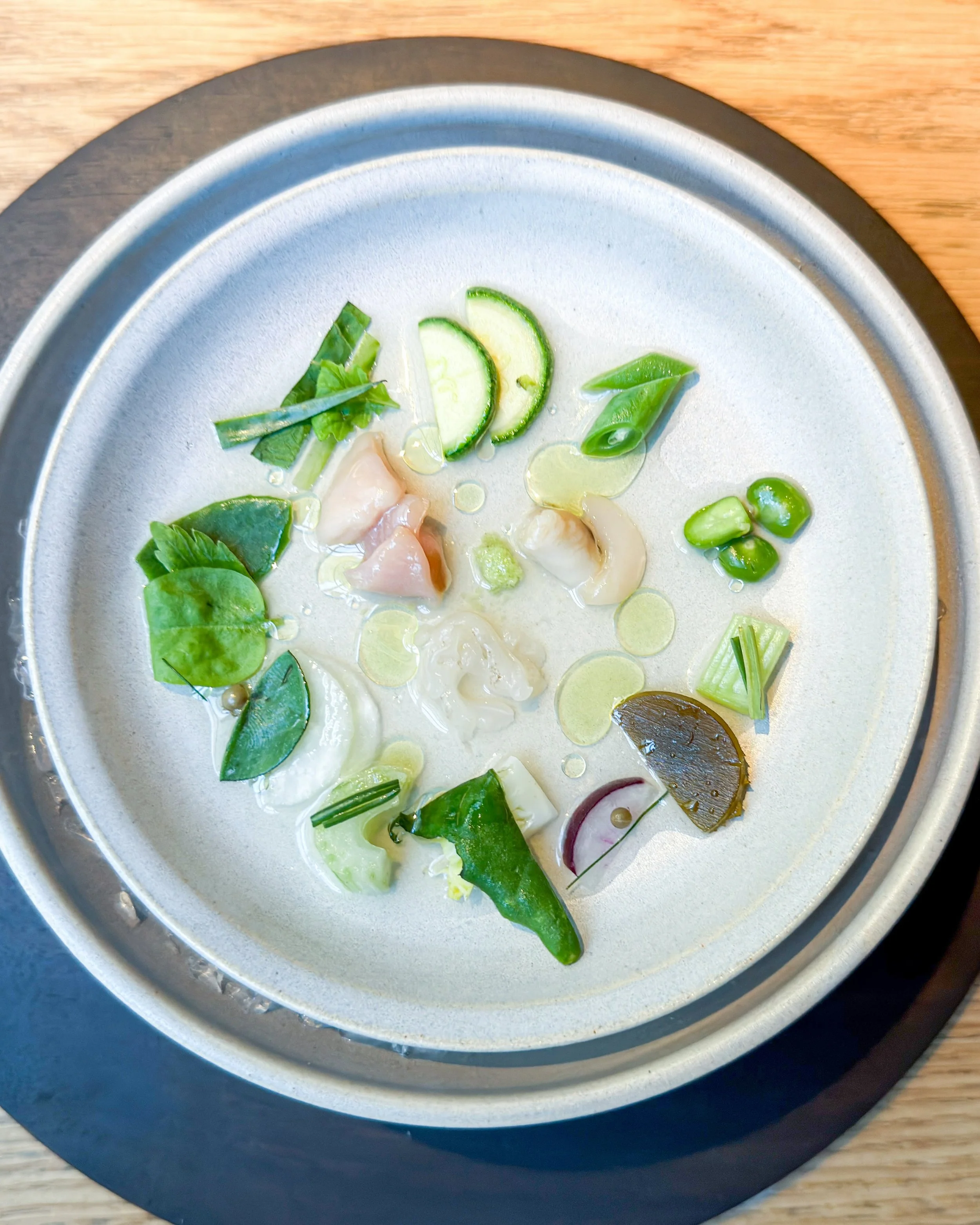 Clams and vegetables.

Wonderful green freshness, served at a cool temperature &mdash; cold as an ingredient in its own right. This deliberate use of temperature became a recurring theme throughout the menu. 

At now three-Michelin-starred Kadeau in 