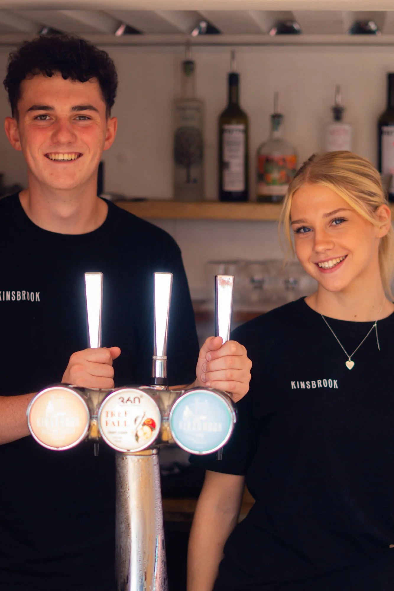 Two Kinsbrook members of staff behind the bar