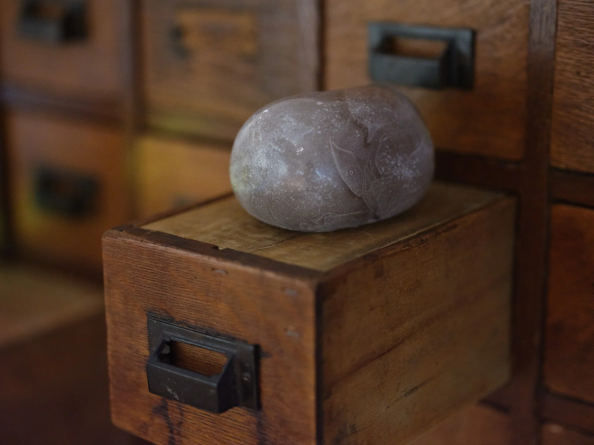 Glass on wooden drawer. Installation detail from The Day Lasts More than a Thousand Sunsets by Artist Rae Stern. Photo by T Maxwell Wagner