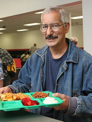 Image of a client holding a tray of food